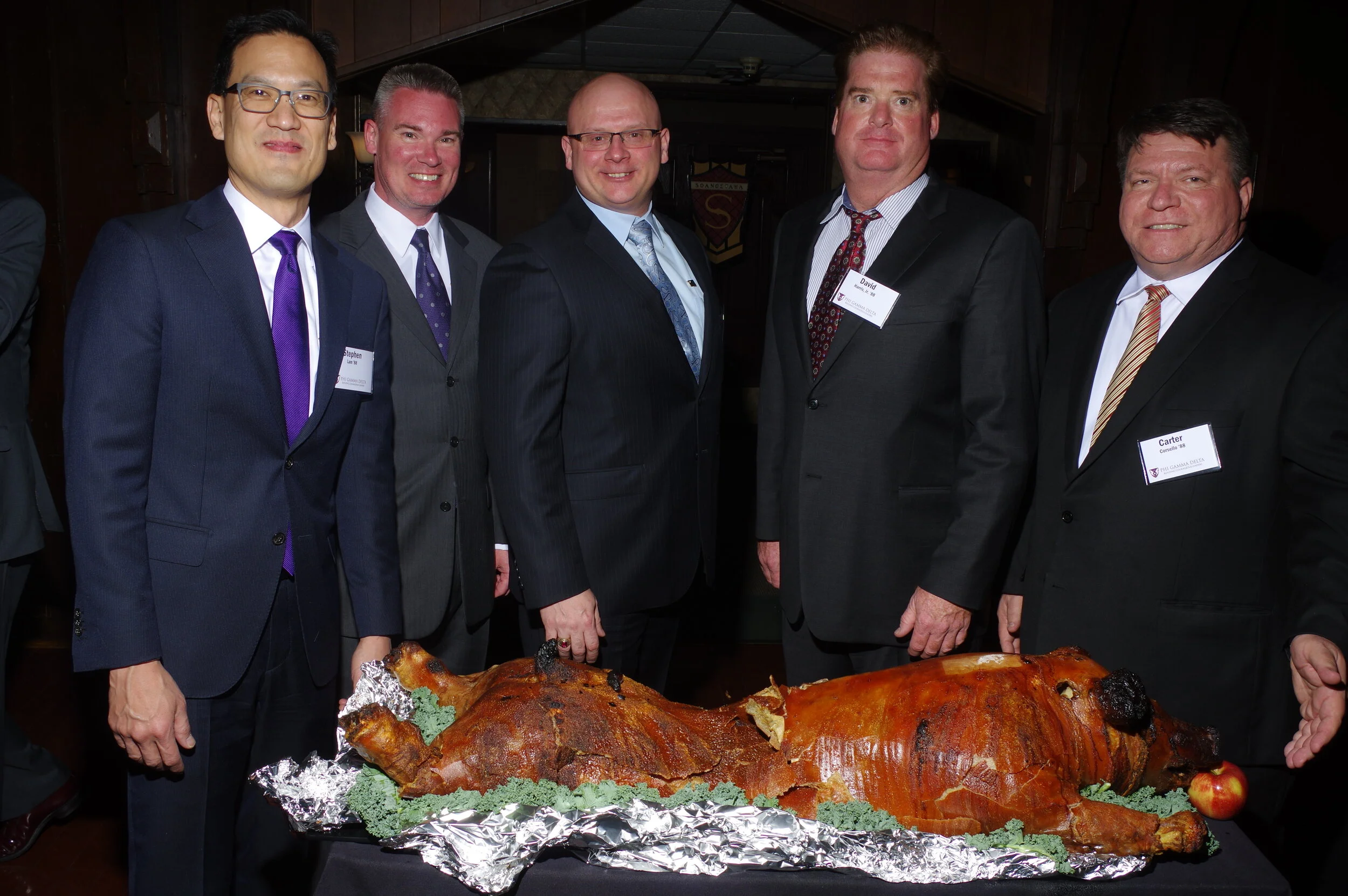 A group of grads from the late 1980s poses with the pig.JPG