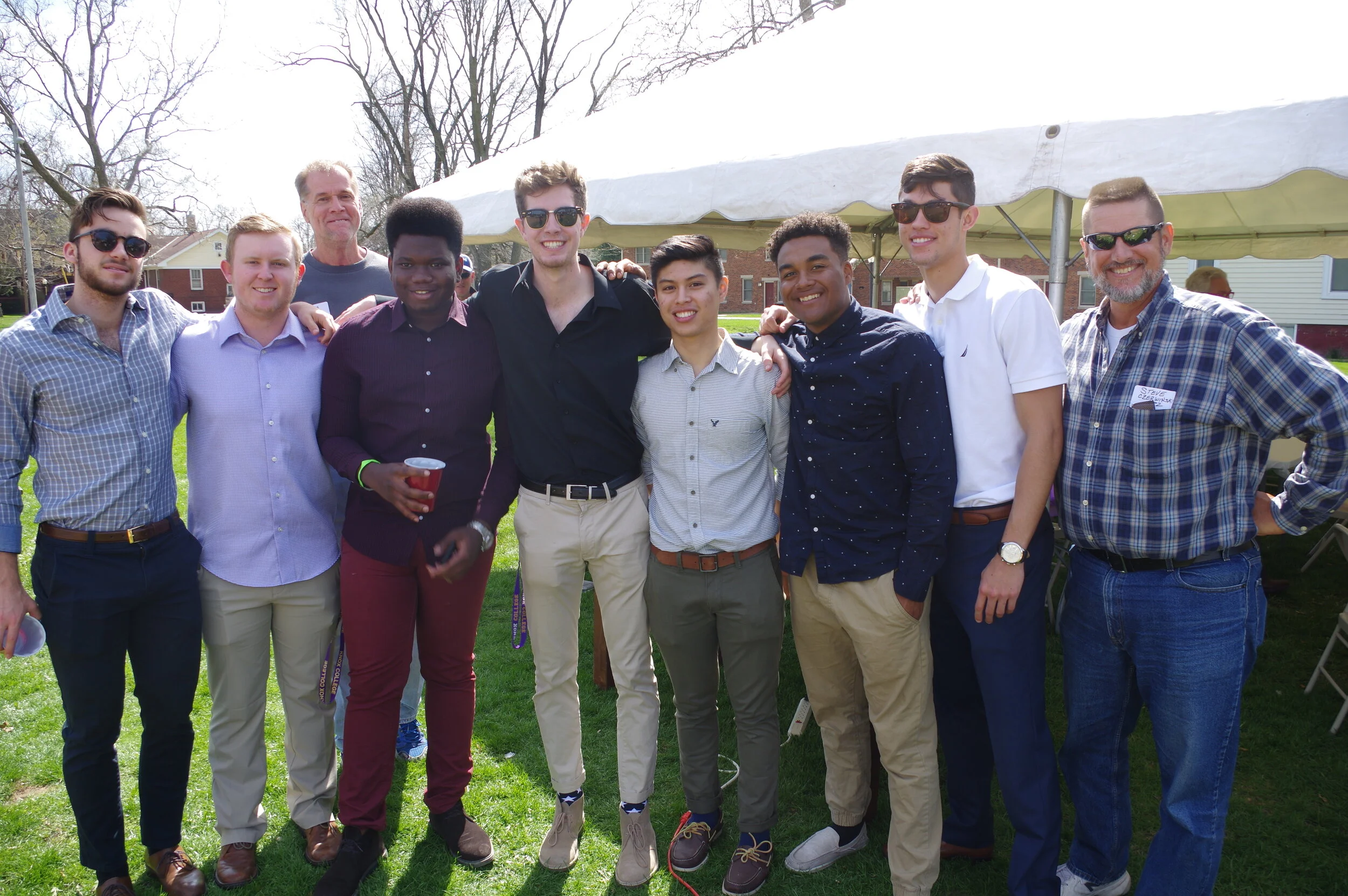 A couple of grads from the early 1980s pose with current undergrads.JPG