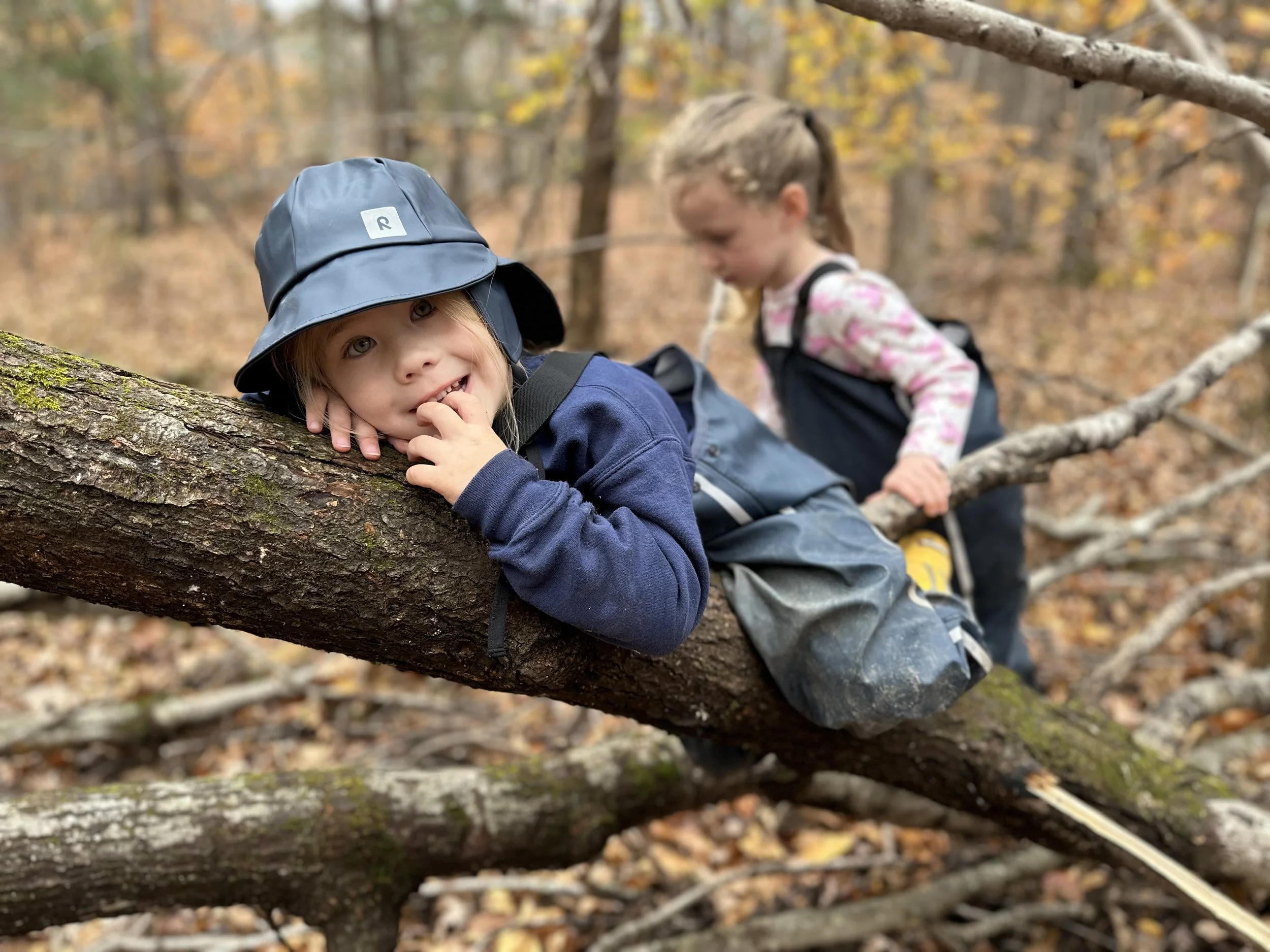 Aiden cuteness on log rain gear.jpeg