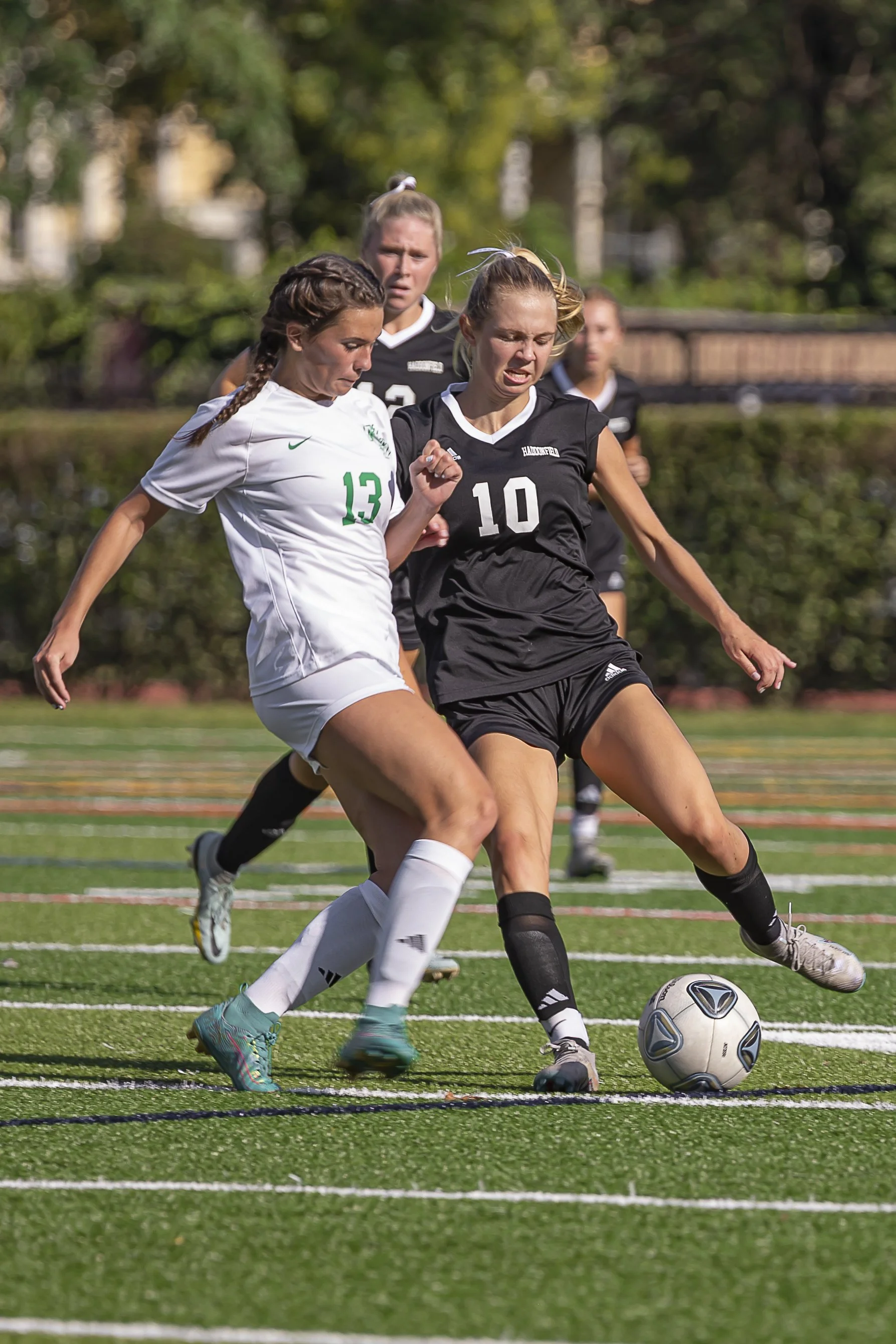 Competitive defensive play during a high school girls' soccer game in Haddonfield, New Jersey.