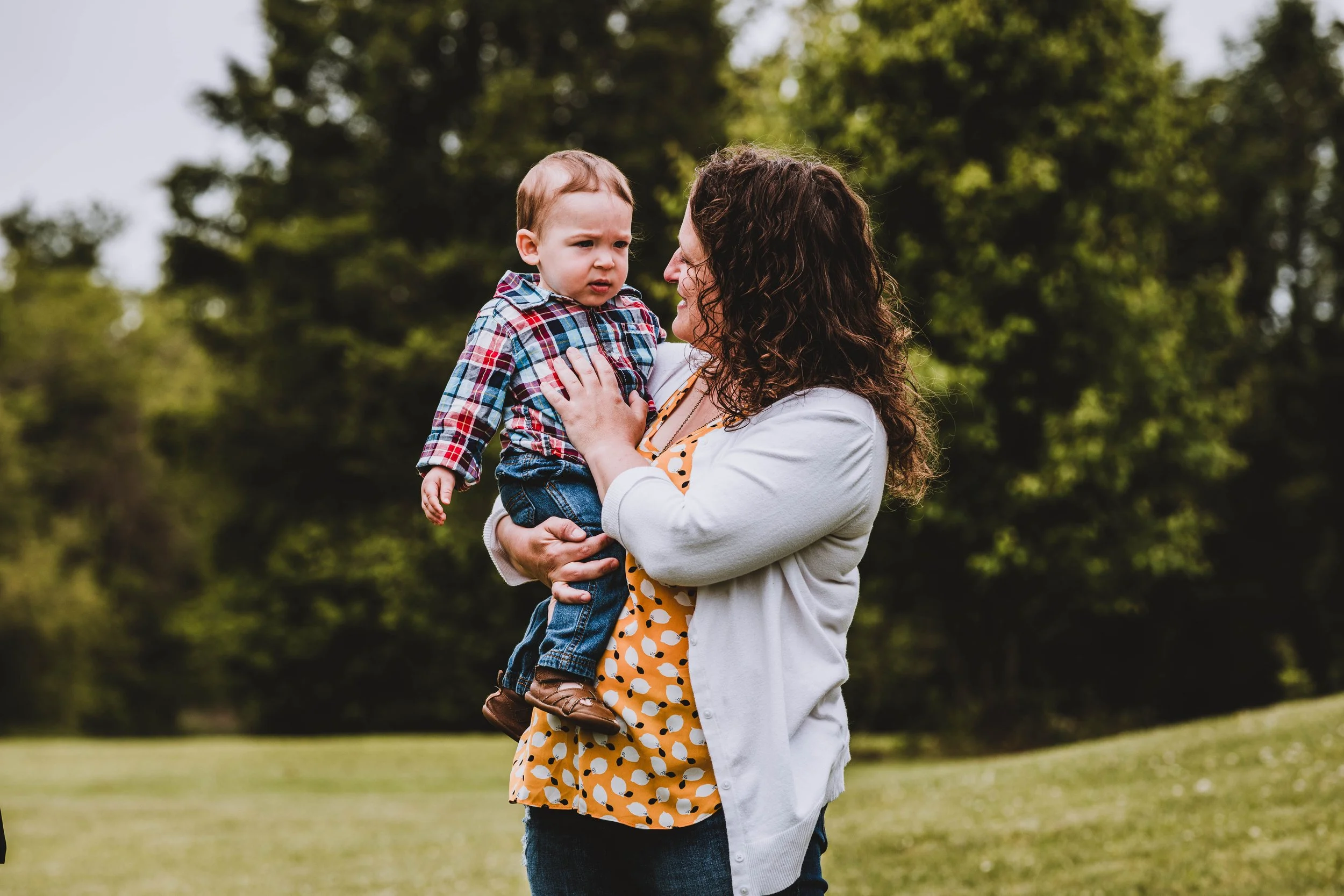Mother holding young child during outdoor family portrait session in Woodstown New Jersey, photographed by Digital Imageries Photography.