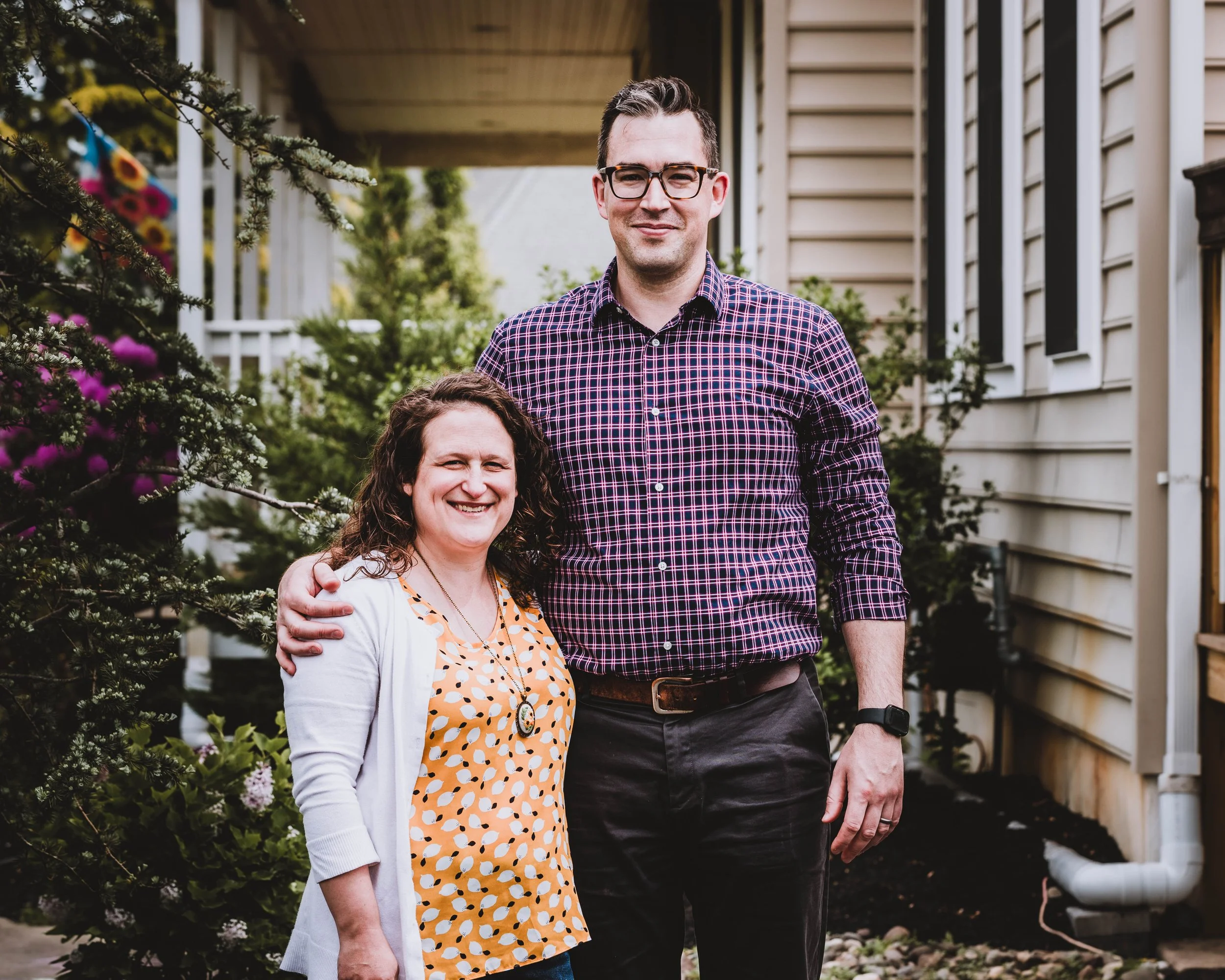 Couple standing outside home during outdoor family photography session in Woodstown New Jersey, photographed by Digital Imageries Photography. 