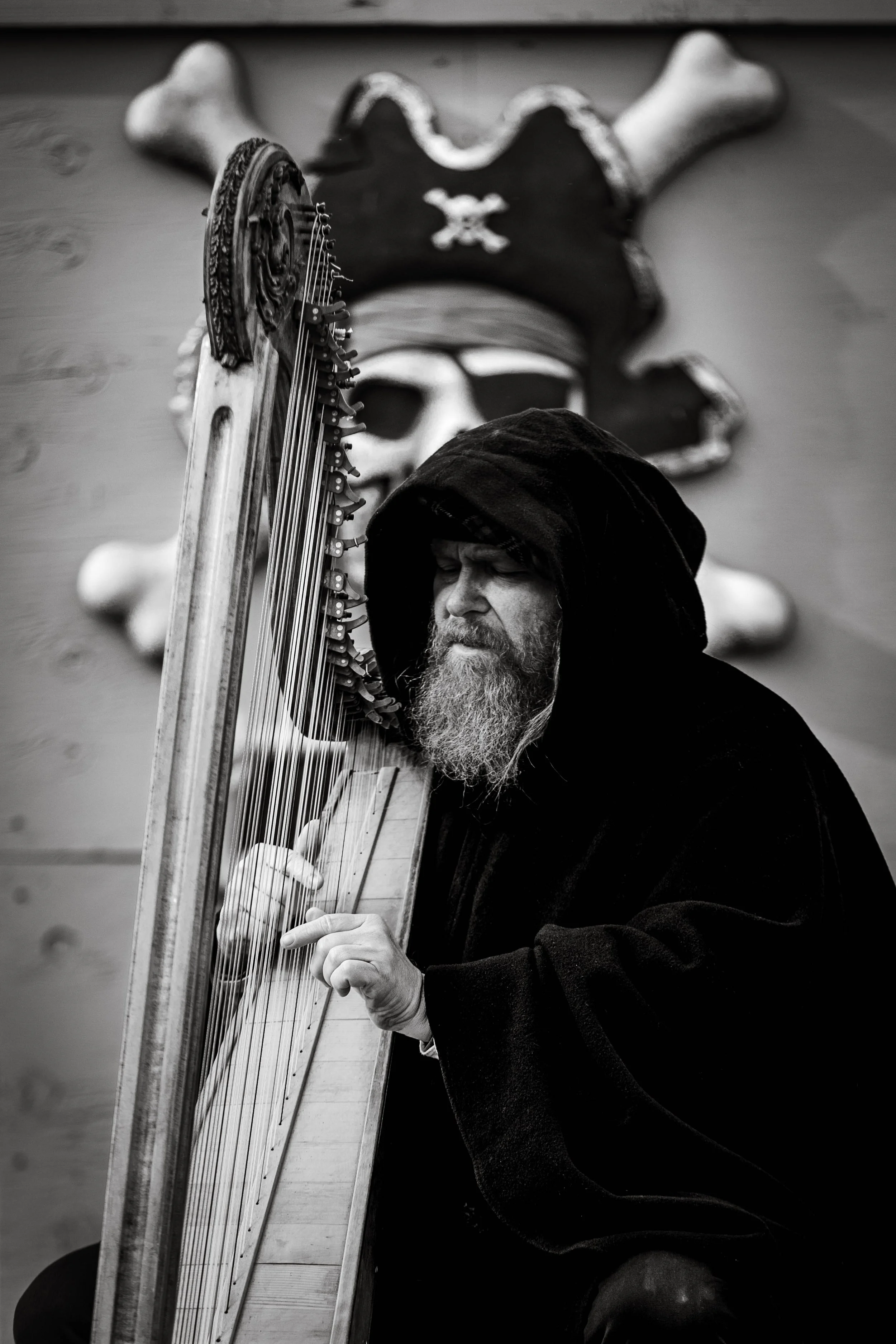 Black and white portrait of musician playing harp at themed event photographed by Digital Imageries Photography in South Jersey.