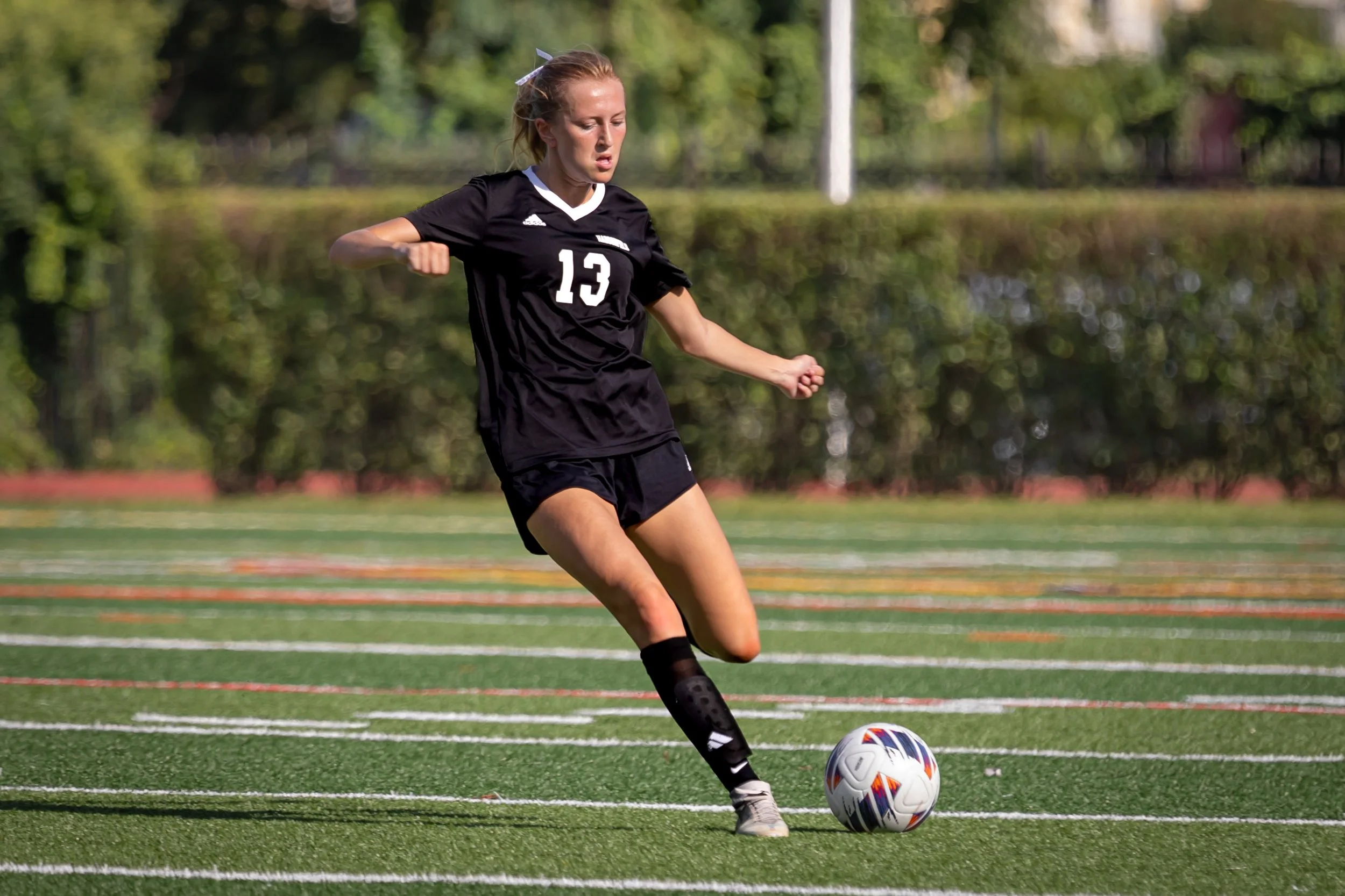 Varsity girls' soccer player in action during a Haddonfield Memorial High School home game.