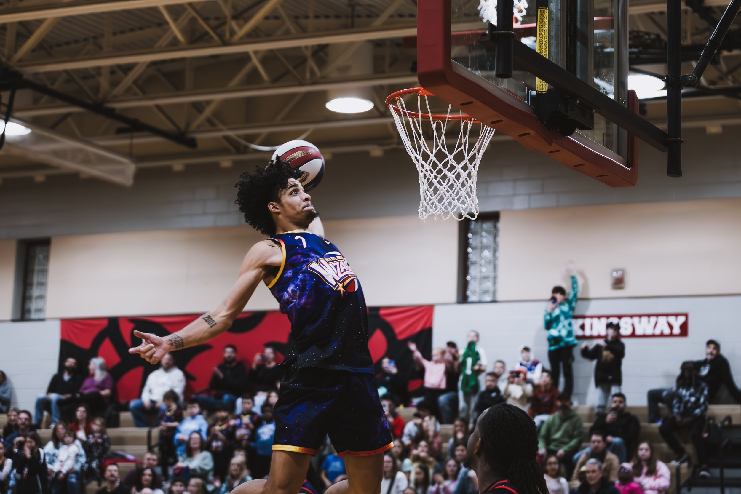 Action shot of a Harlem Wizards basketball player during a community fundraiser event at Swedesboro-Woolwich School District.