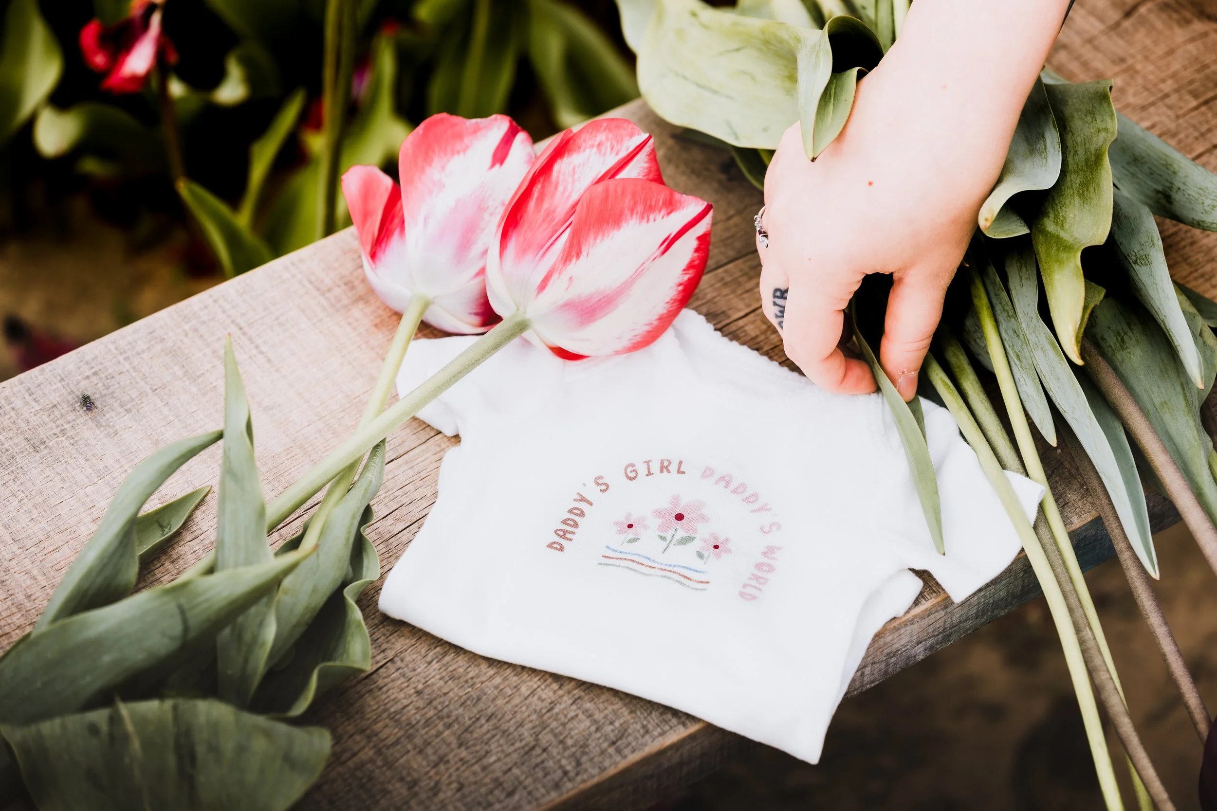 Flat lay wedding detail with fresh tulips and stationery, captured in natural light for a romantic, editorial look.