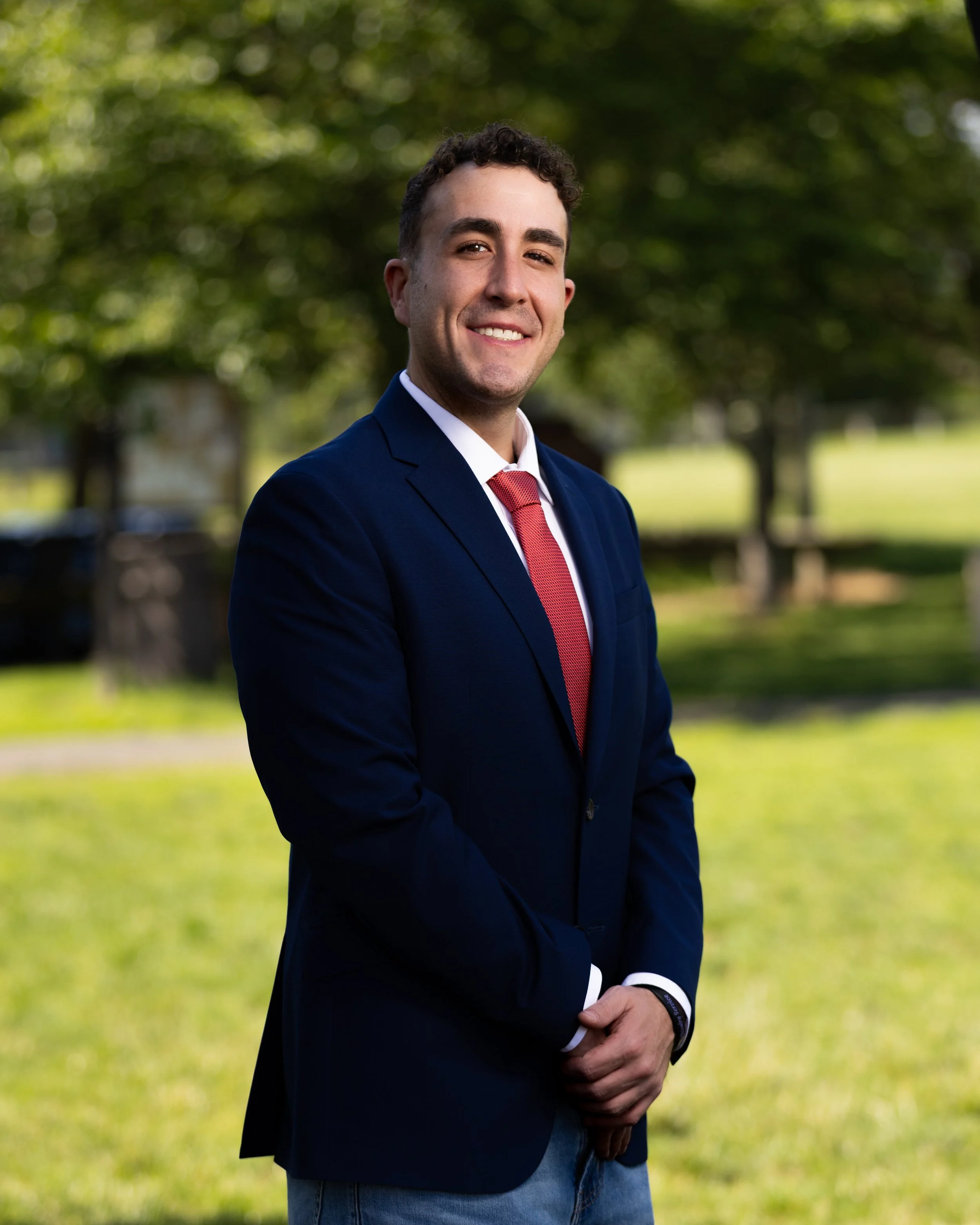 Professional portrait of a man in a suit, captured outdoors with natural light for business, branding, and corporate headshot use.