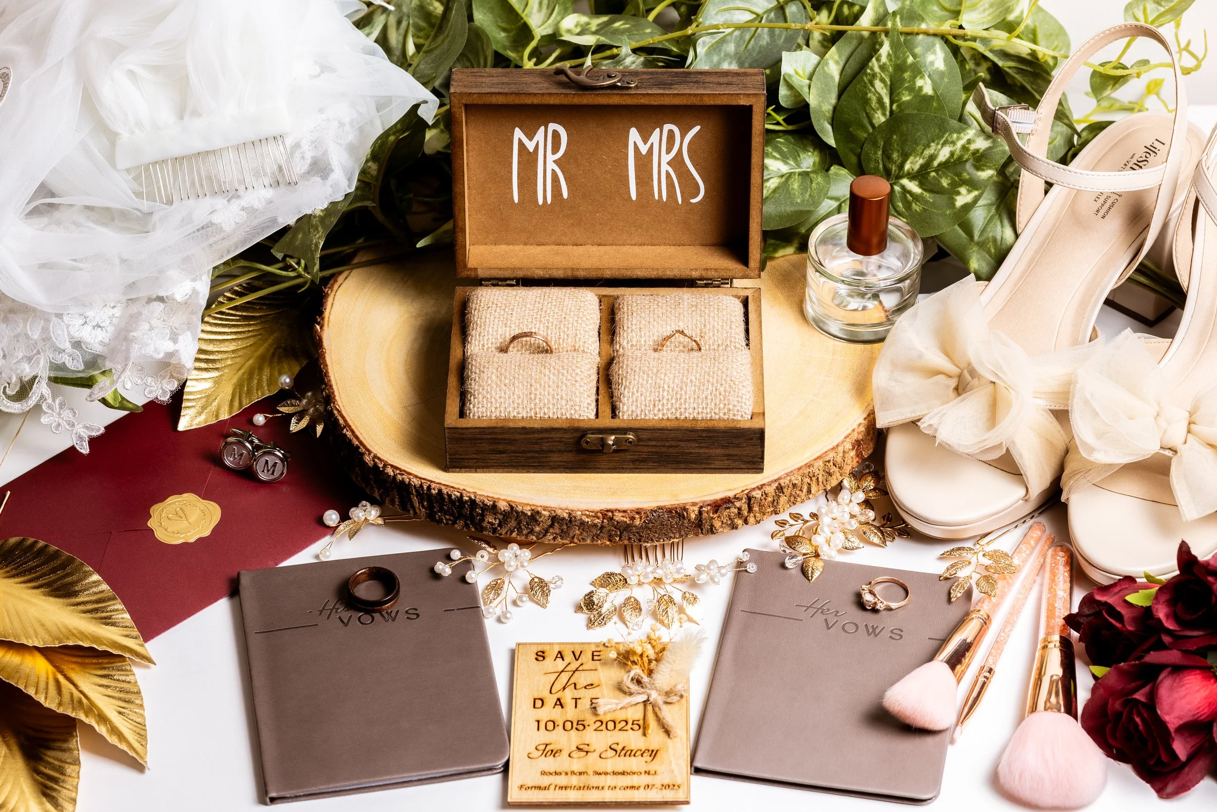 Wedding detail flat lay featuring engraved wooden elements, wedding rings, and invitation stationery, styled for a romantic wedding aesthetic.