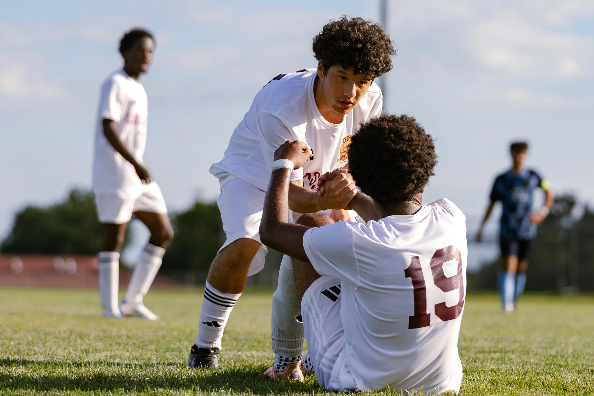 A moment of sportsmanship as a Glassboro player helps up his teammate up during their varsity soccer scrimmage.