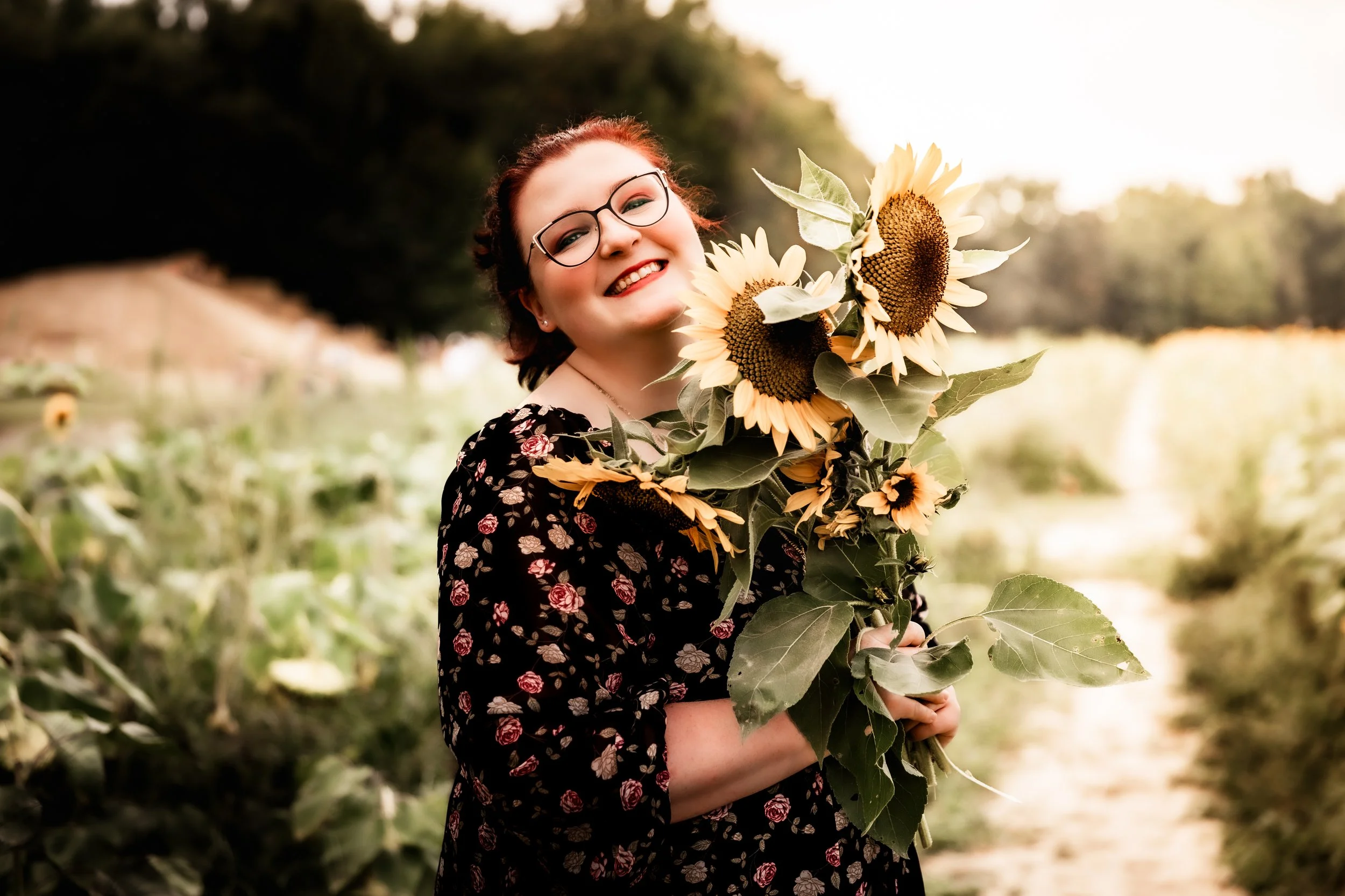 Outdoor portrait of a woman holding sunflowers at Dalton Farms in South Jersey, captured during golden hour by Digital Imageries Photography.