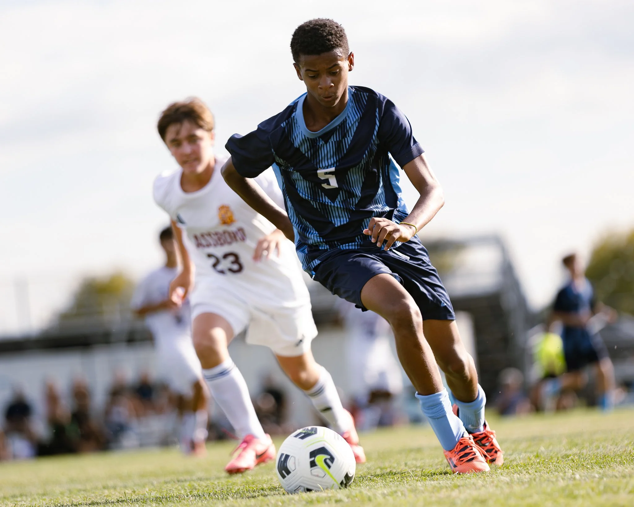 A Highland Regional striker maneuvers past a Glassboro defender during a competitive varsity soccer scrimmage.