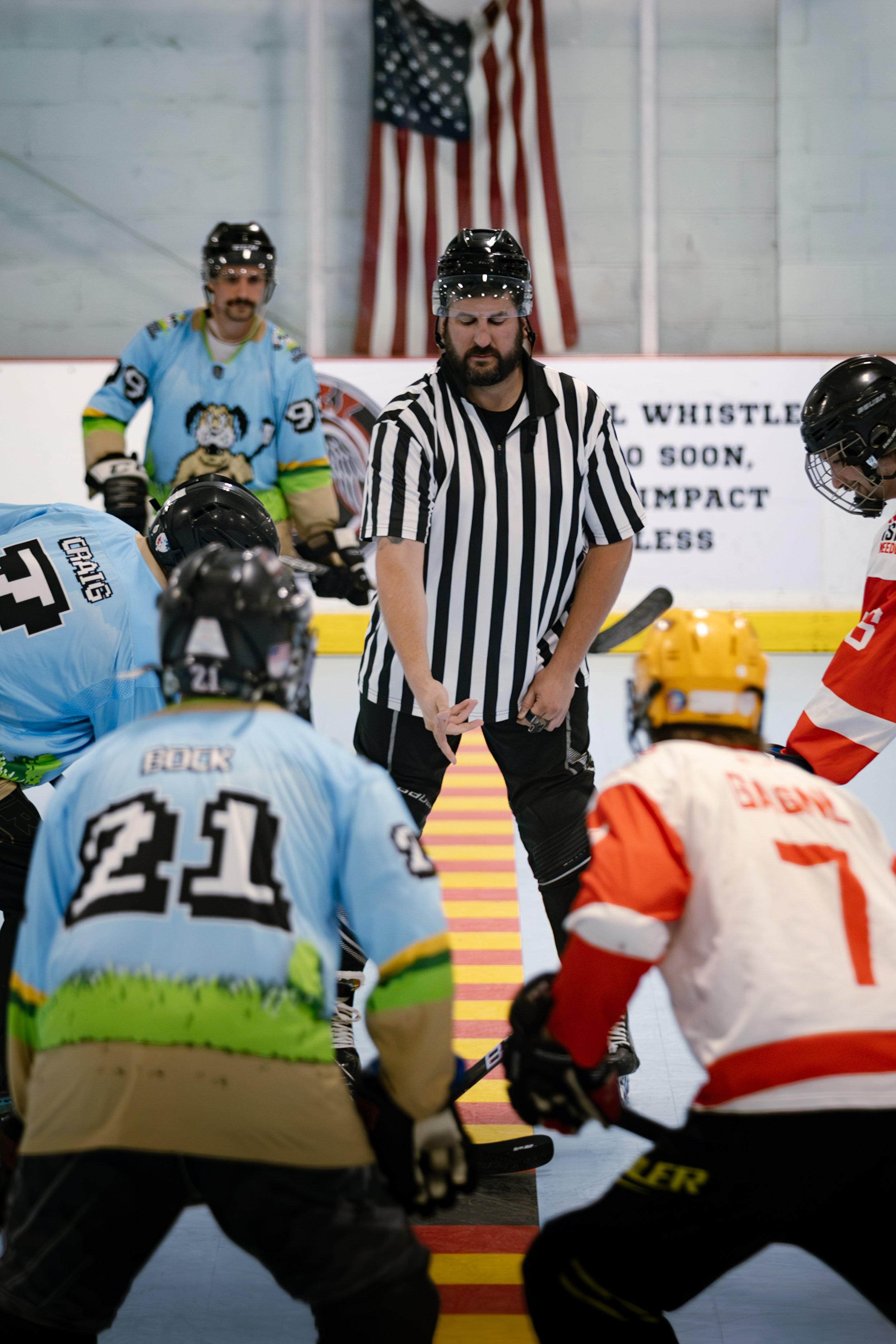 Referee preparing to drop the puck before a roller hockey faceoff at Choice Inline Arena in Pitman, New Jersey