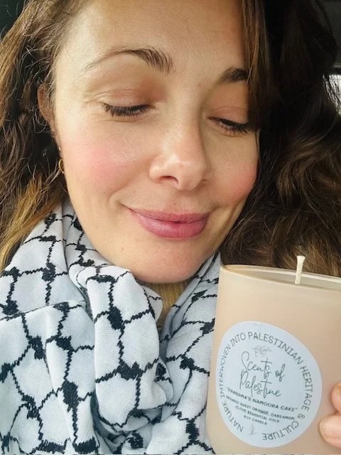 lady holding candle with palestinian label