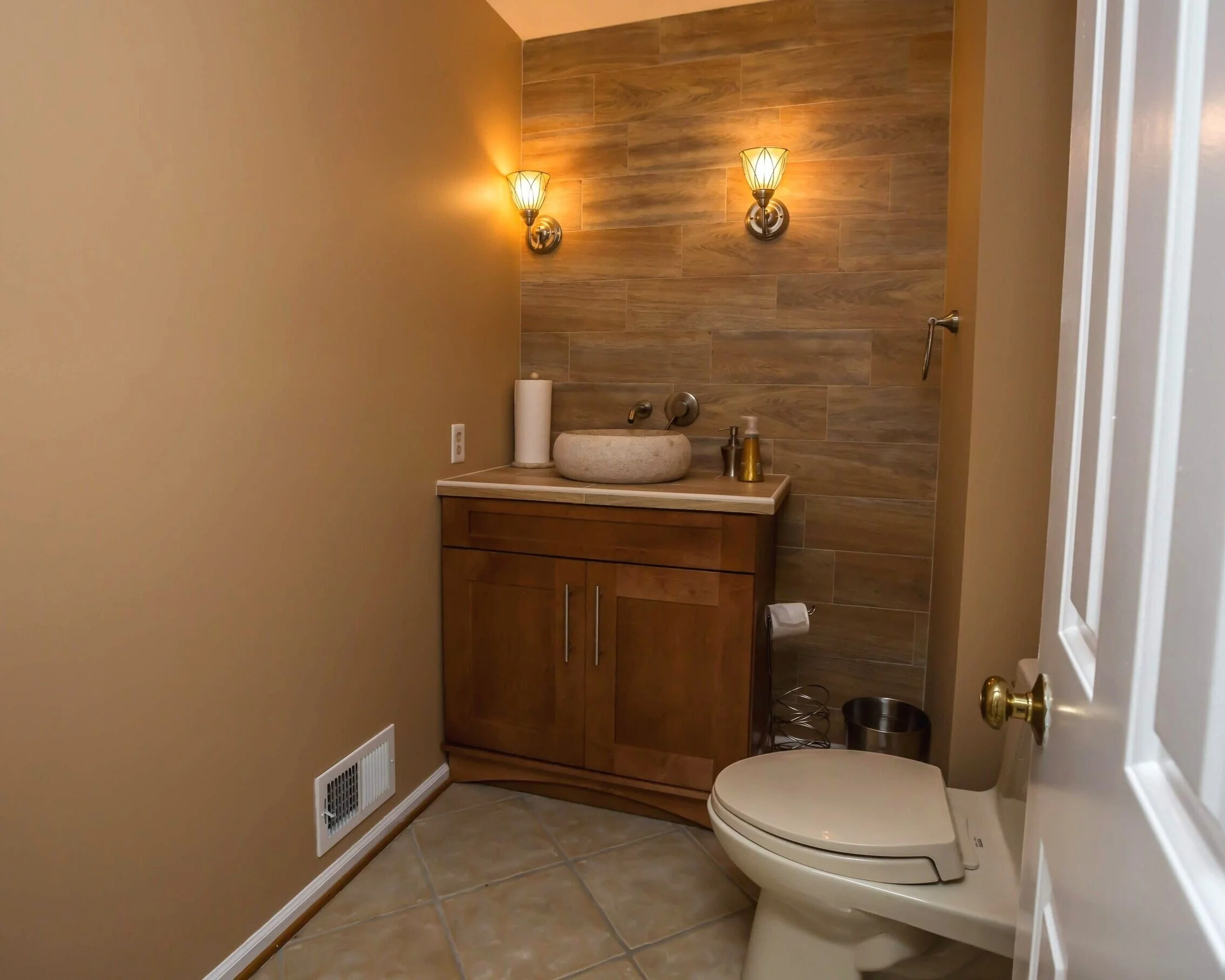 Here, Javier’s warm bath fixtures are coupled with a meditative combination - the stone bowl sink and smooth wall tiling.