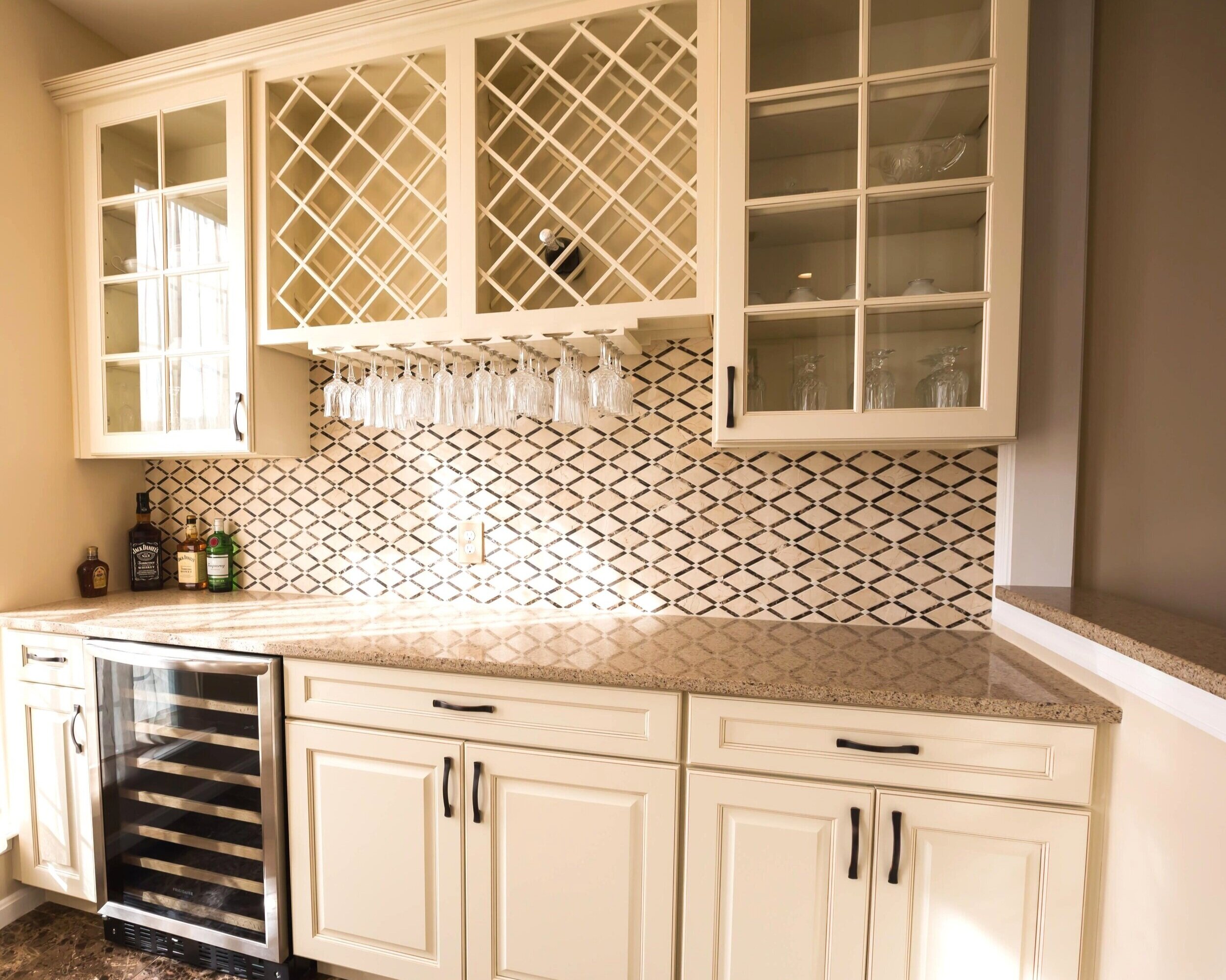For a family with fine tastes: an economic yet tasteful wine rack, complete with hanging glasses, and custom kitchen cabinetry.