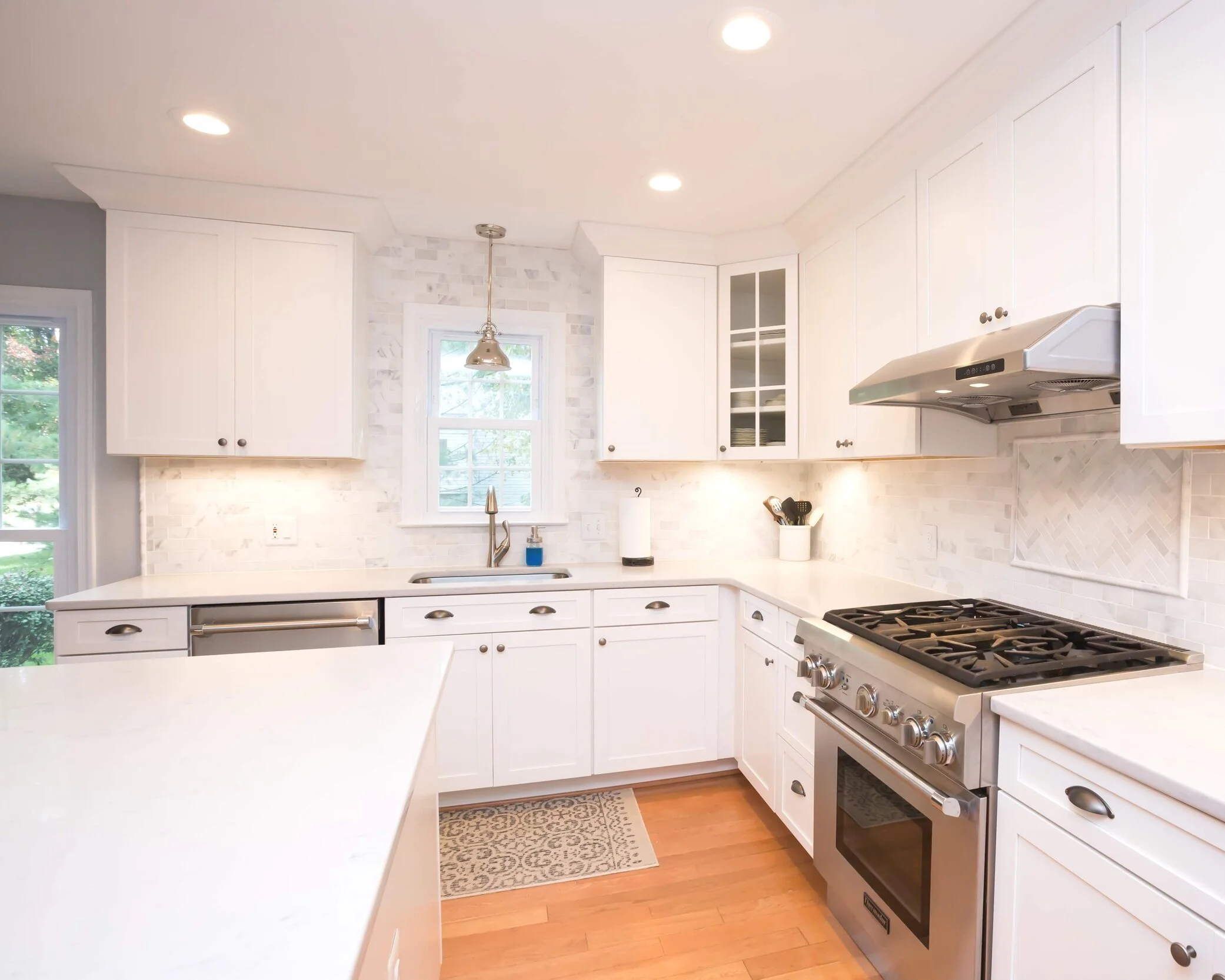 Javier’s custom kitchen cabinets, framed by an expert balance of indoor and outdoor lighting.