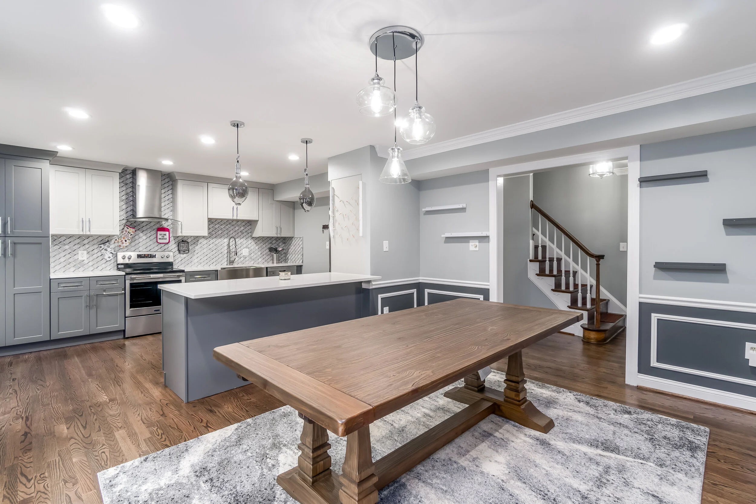 You’ll love to host in this expansive kitchen and dining space - complete with a granite countertop island bar and some spectacular overhead lighting.