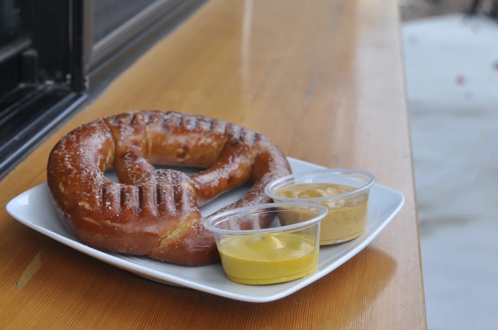 grilled pretzel with beer cheese and mustard