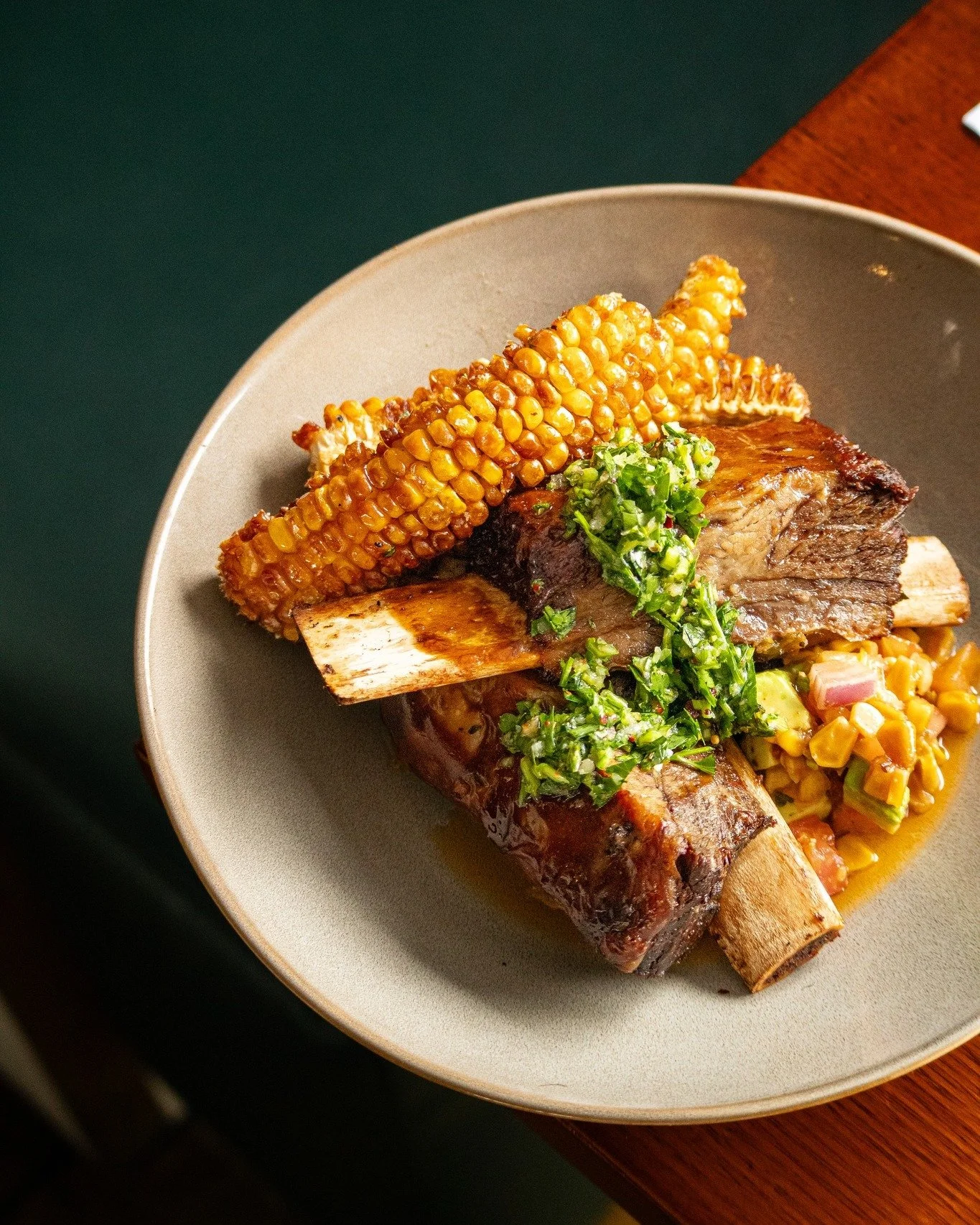 Make your evening a little brighter. Join us for dinner and treat yourself to this week&rsquo;s special: twice-cooked beef ribs served with buttered corn. Reserve your table now through the link in our bio.

#thecamden #specialoffer #foodphotography 