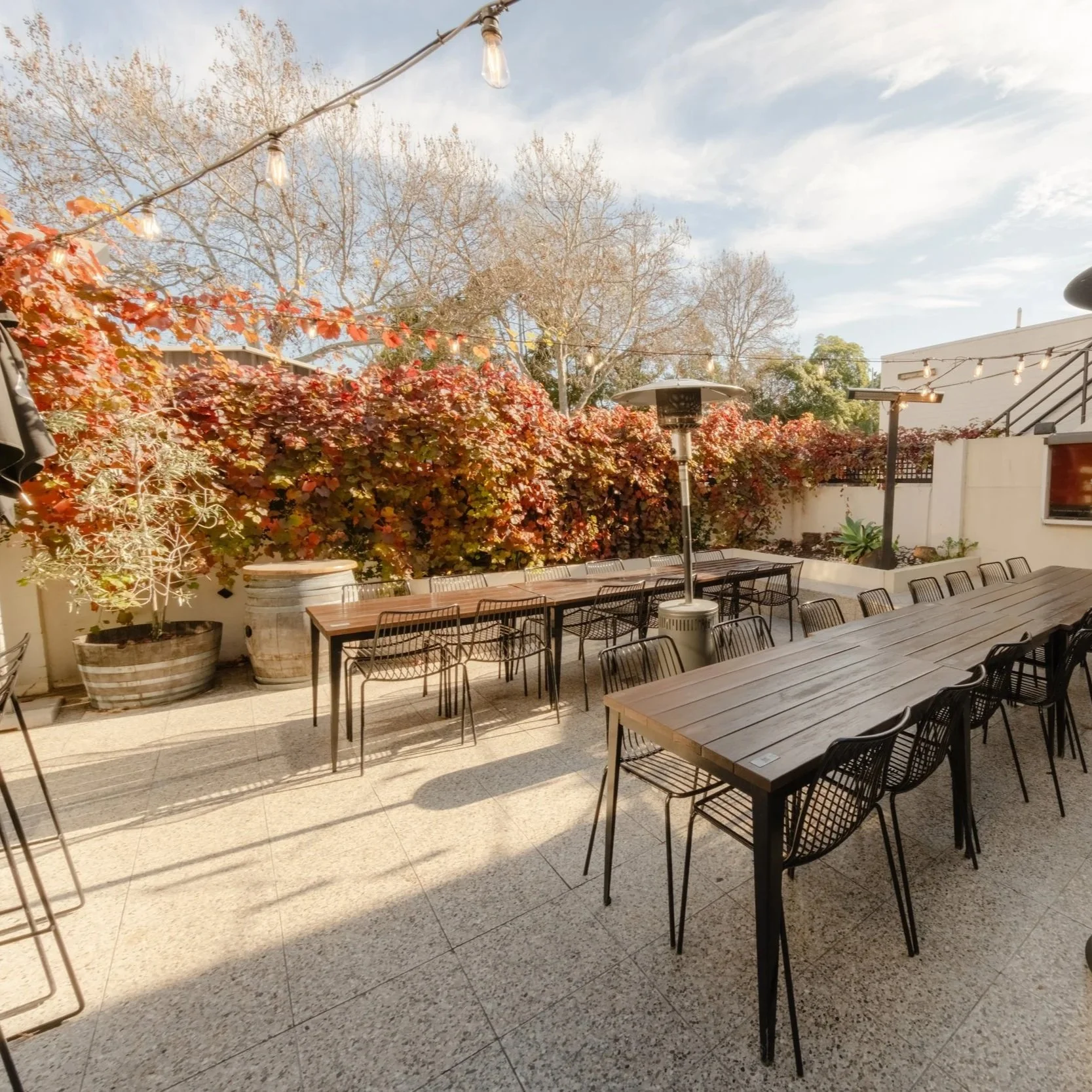 A sunny courtyard  and beer garden at the Camden Hotel with blue sky and lovely settings, perfect for a gathering or private function