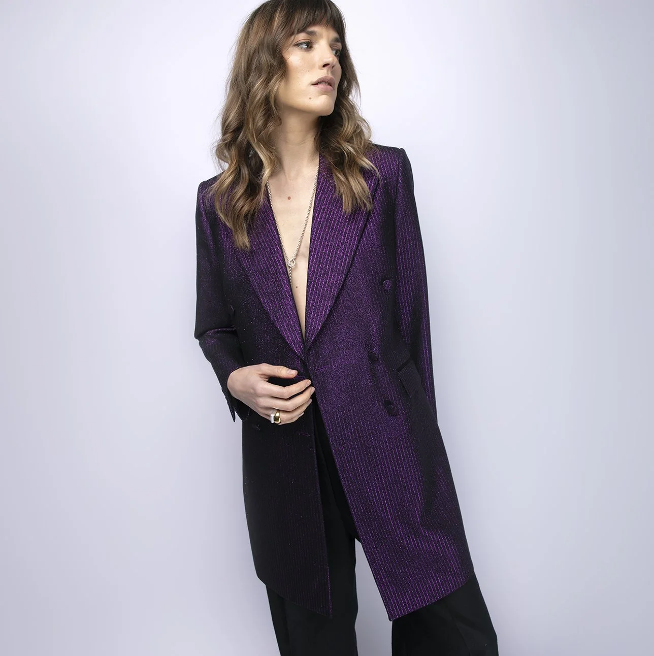 Banshee of Savile Row bespoke women's tailoring showing a purple glitter single breasted jacket dress with lapel collar and one button.