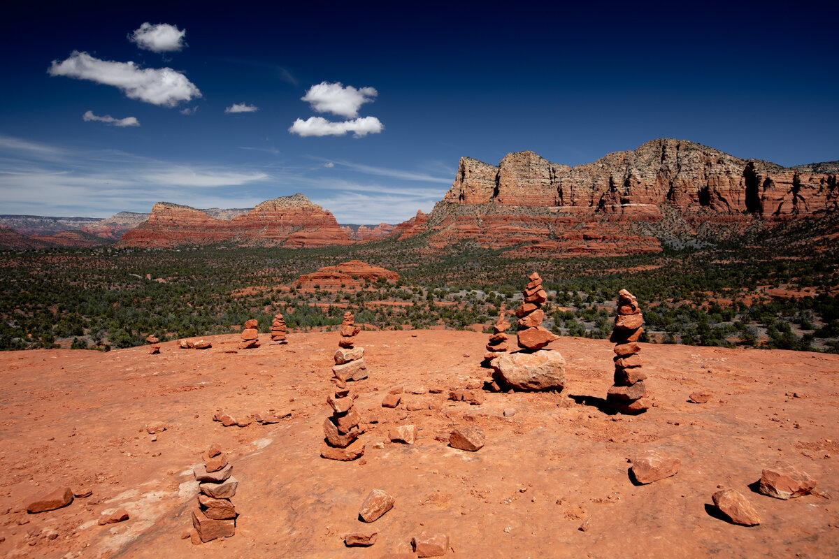 View on top of Bell Rock in Sedona with cairns in foreground