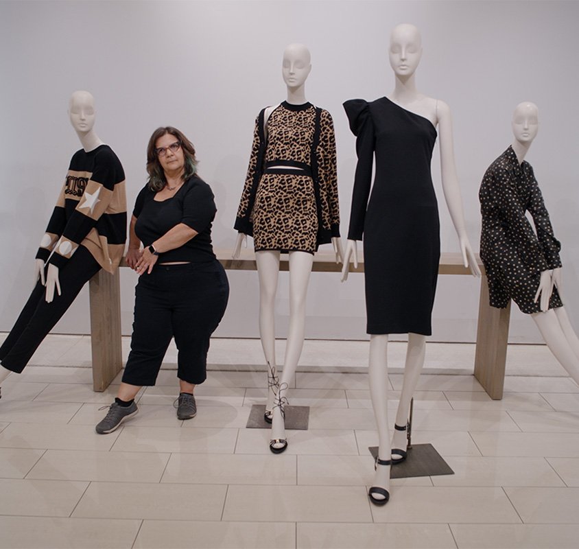 woman standing with mannequins