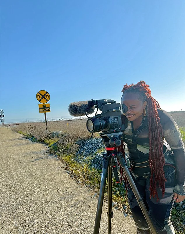 woman behind camera