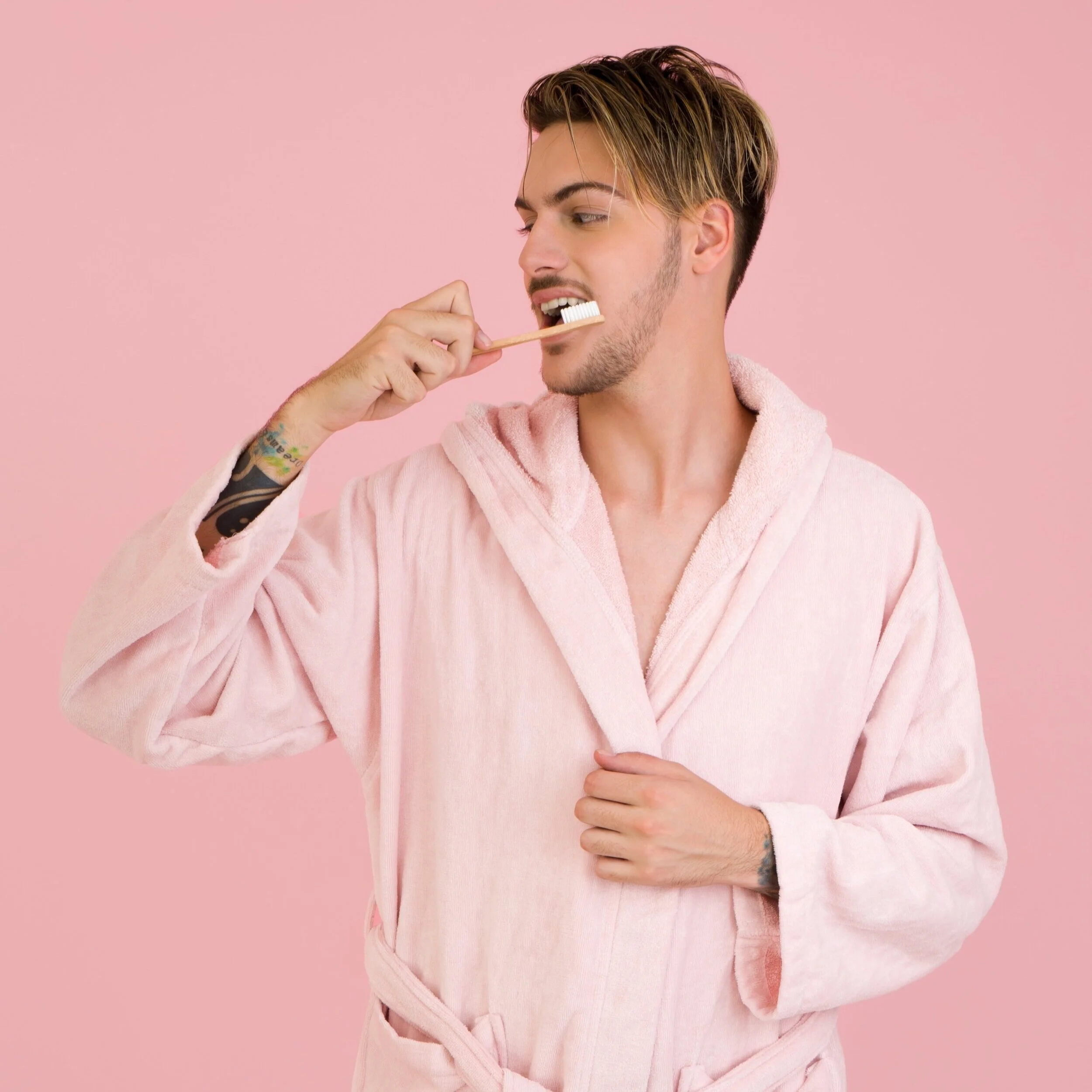 man-wearing-bathrobe-brushing-his-teeth-1040821.jpg