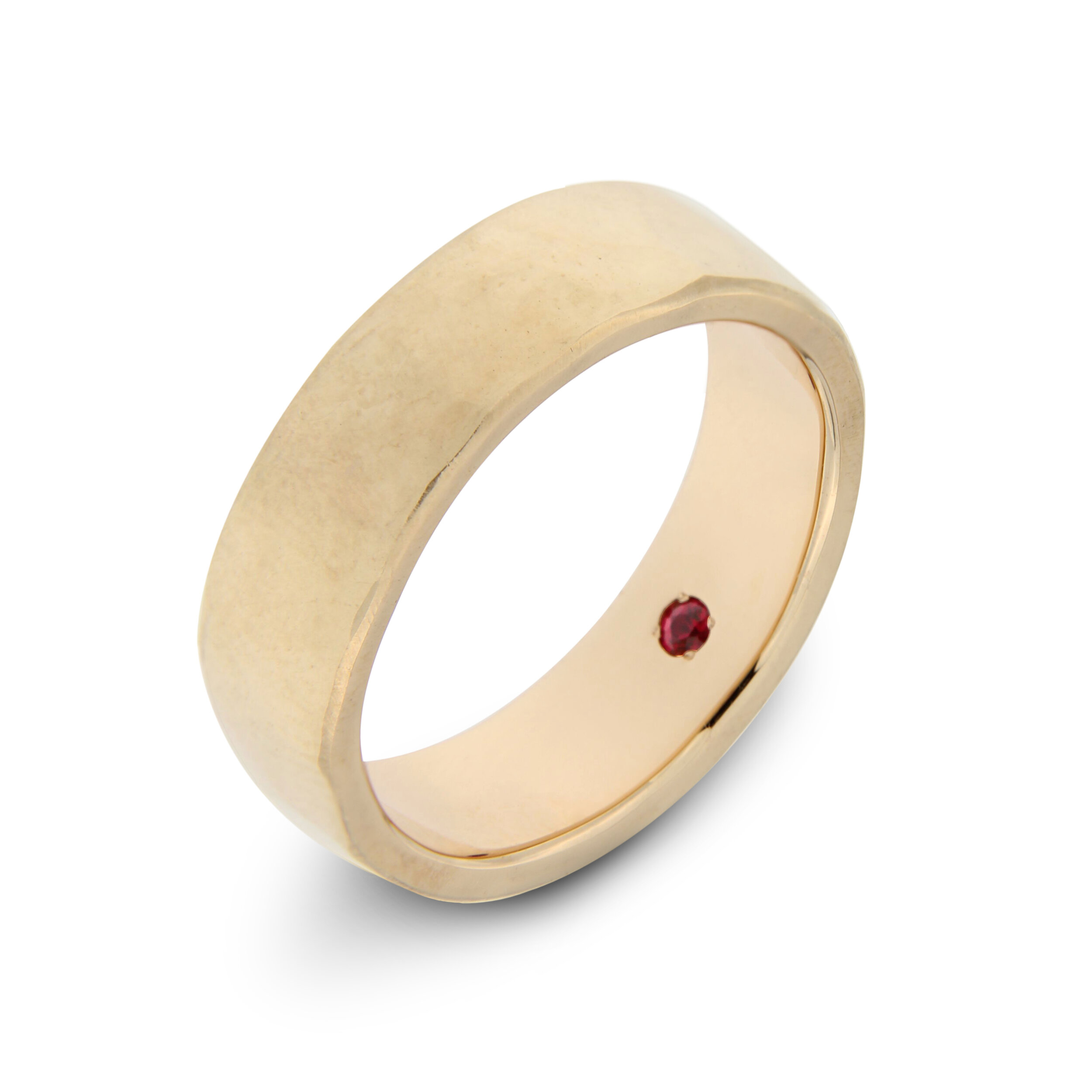 Custom lightly texturised gentlemens ring in 14kt. roségold with a ruby set on the inside.jpg