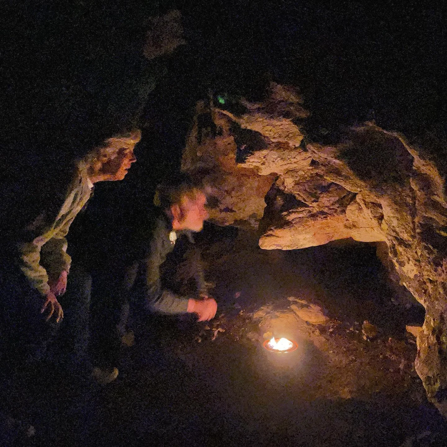 Seeing is Believing.

While Paleolithic humans used torches or made small fires to be able to see in and travel through caves in complete darkness, archaeological evidence of portable lamps and the lack of soot marks on decorated walls or ceilings su