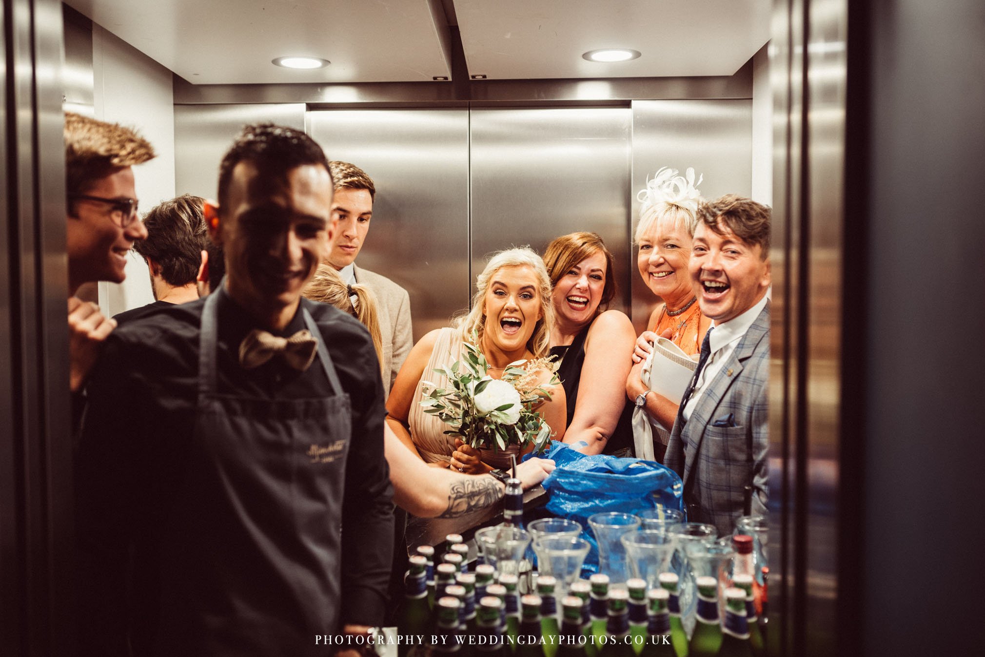 wedding guests squeezing into the lift at manchester hall