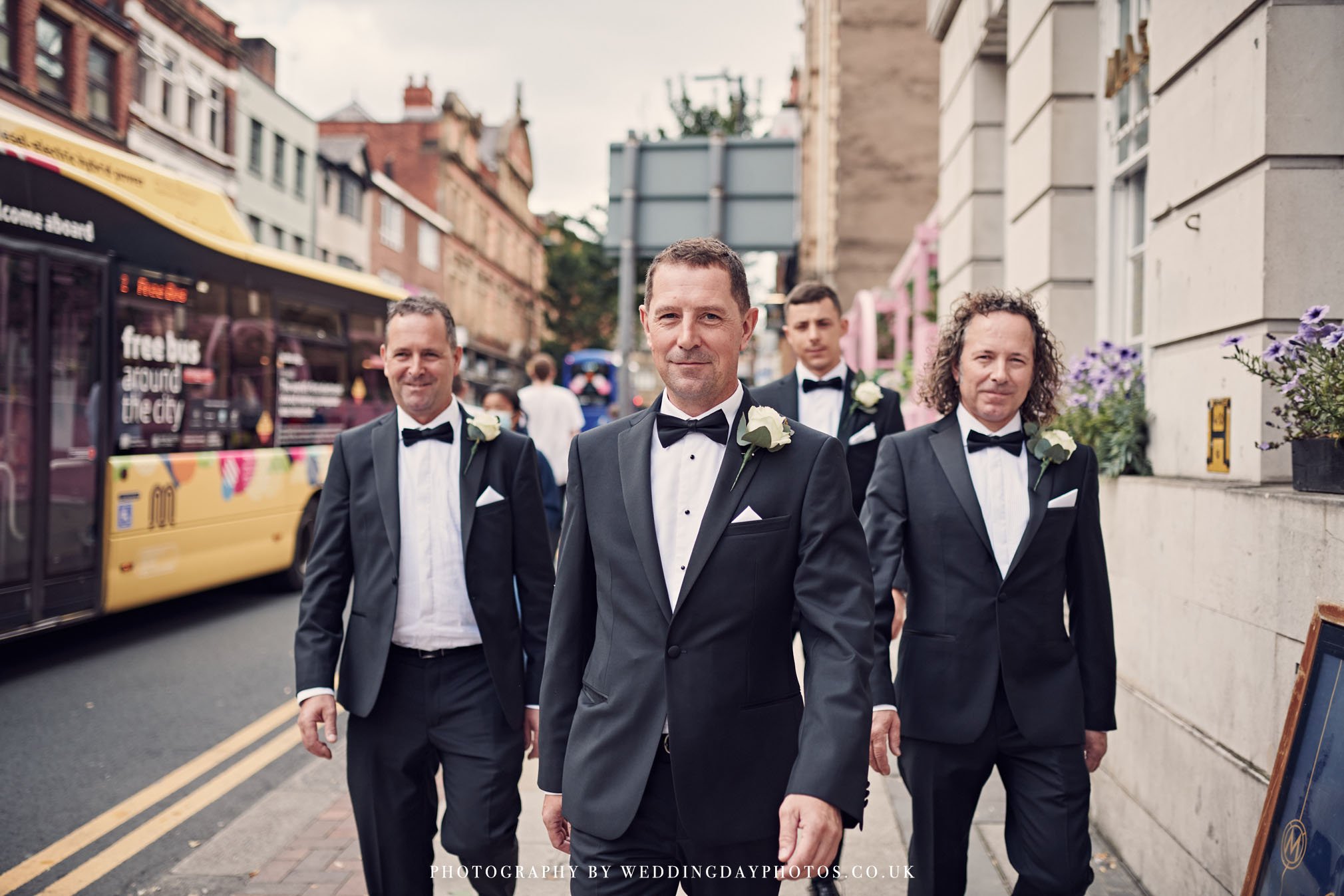 groom and groomsmen photographed outside manchester hall