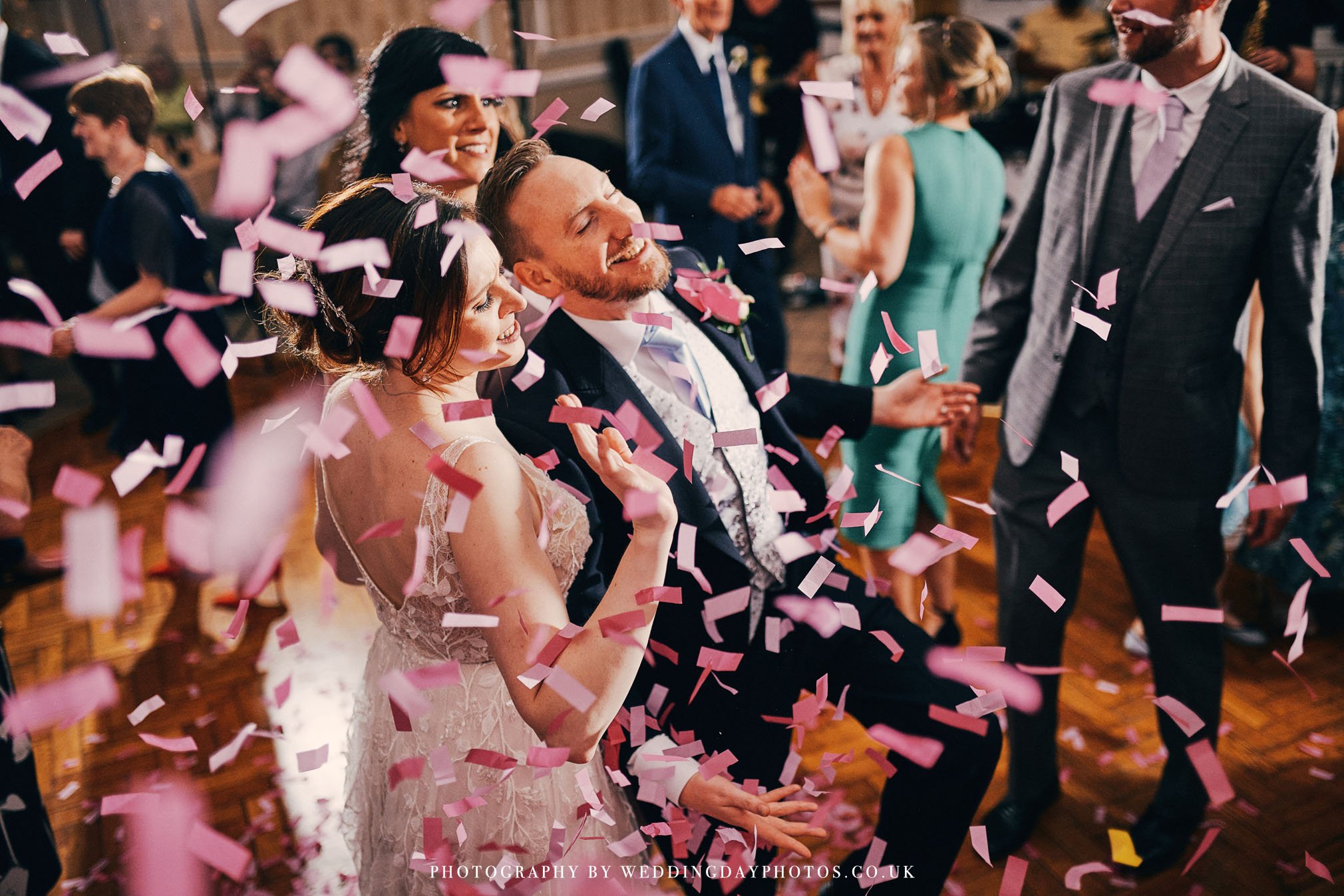 energetic shot of couple dancing with confetti canon at manchester hall wedding
