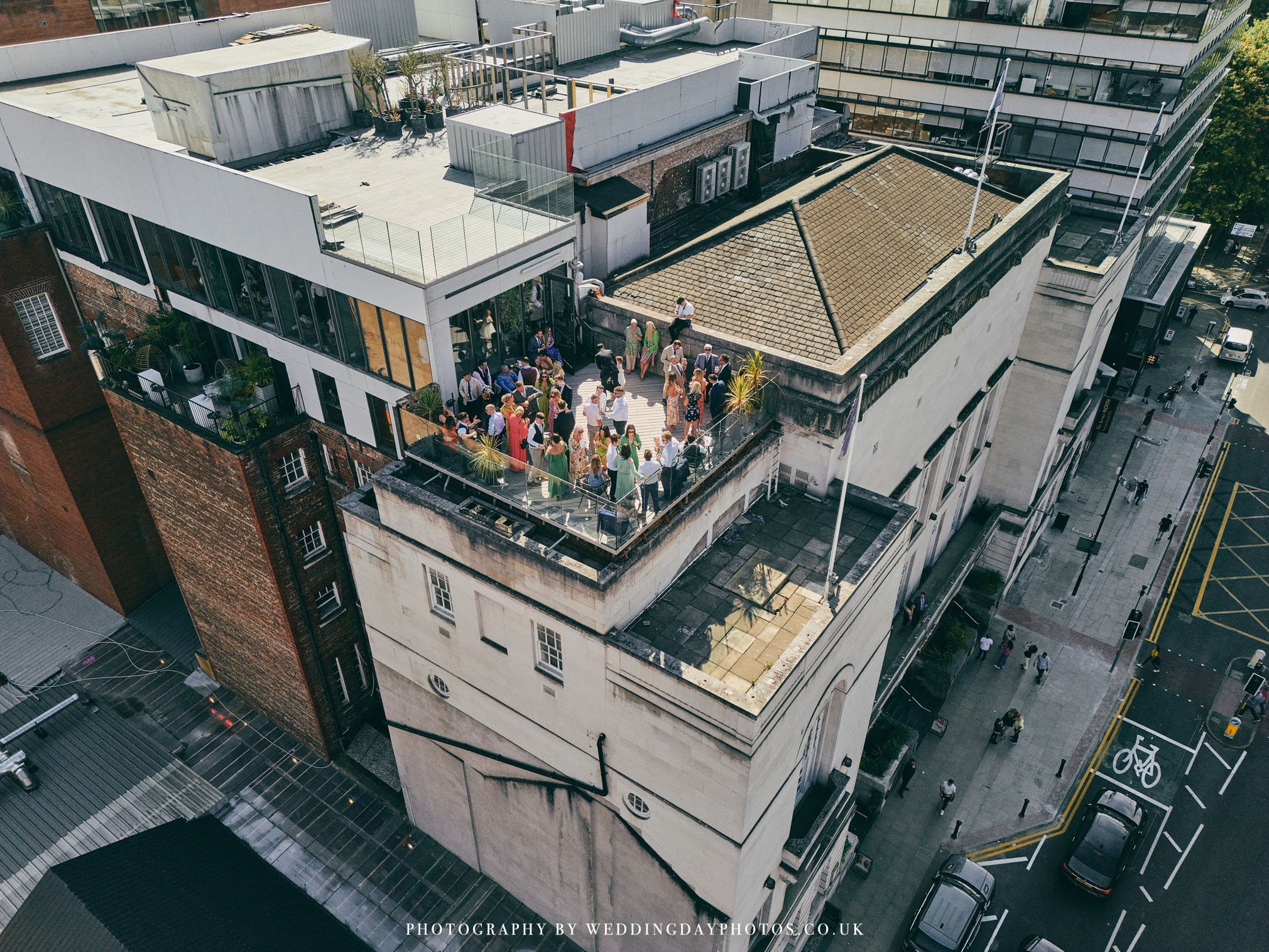 cool image captured from a drone of a manchester hall rooftop wedding drinks reception