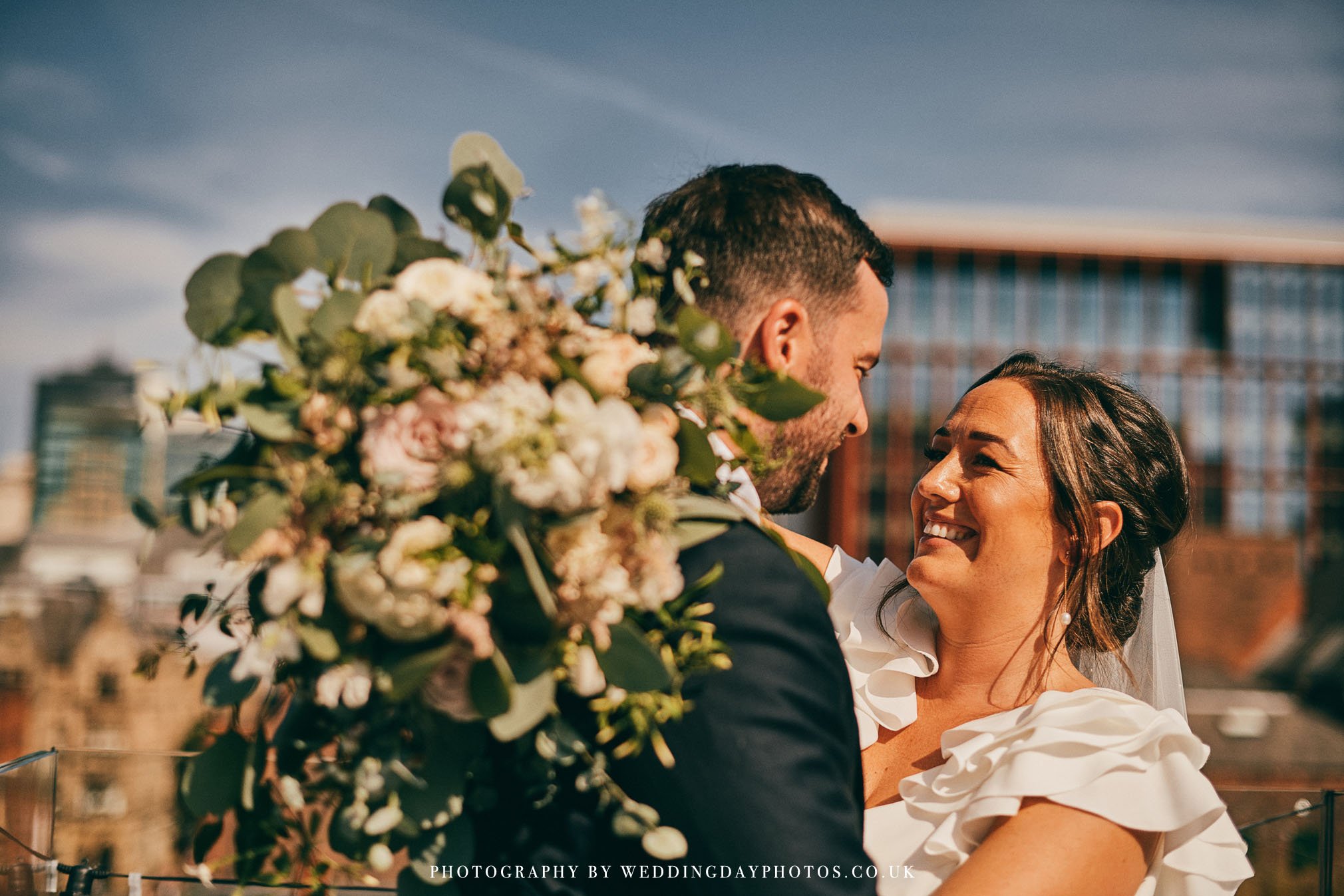 fun couple portrait on rooftop of manchester hall