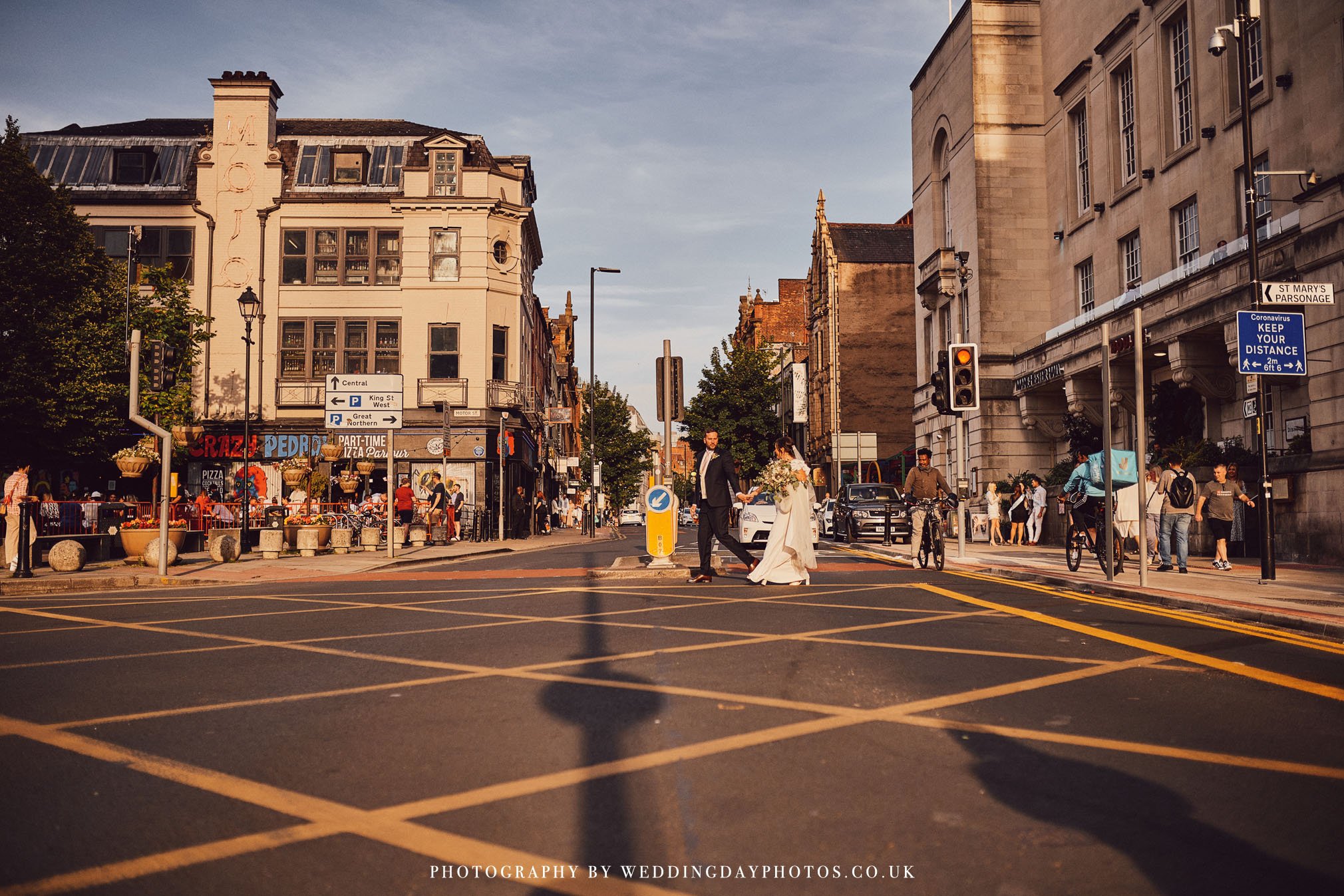 wedding bride and groom crossing bridge street outside manchester hall