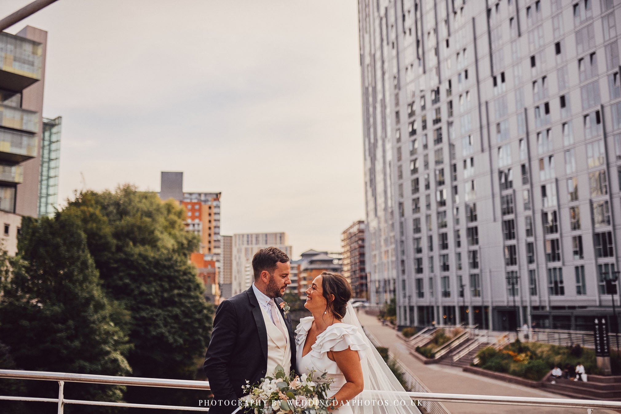 wedding couple relaxing on trinity bridge, perfect wedding at manchester hall