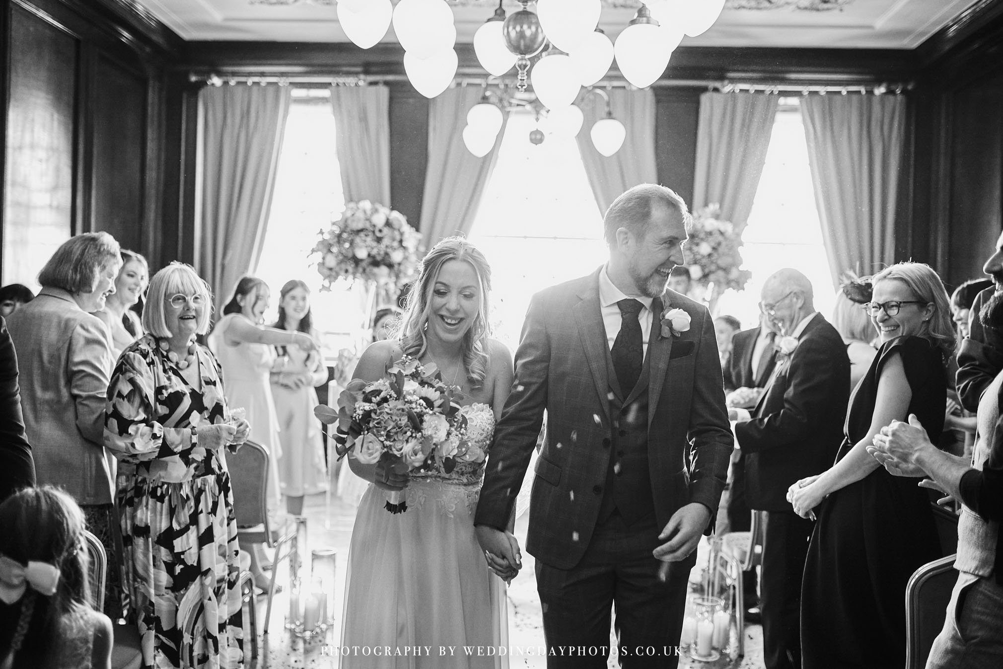 throwing confetti in the drawing room for a wedding at manchester hall