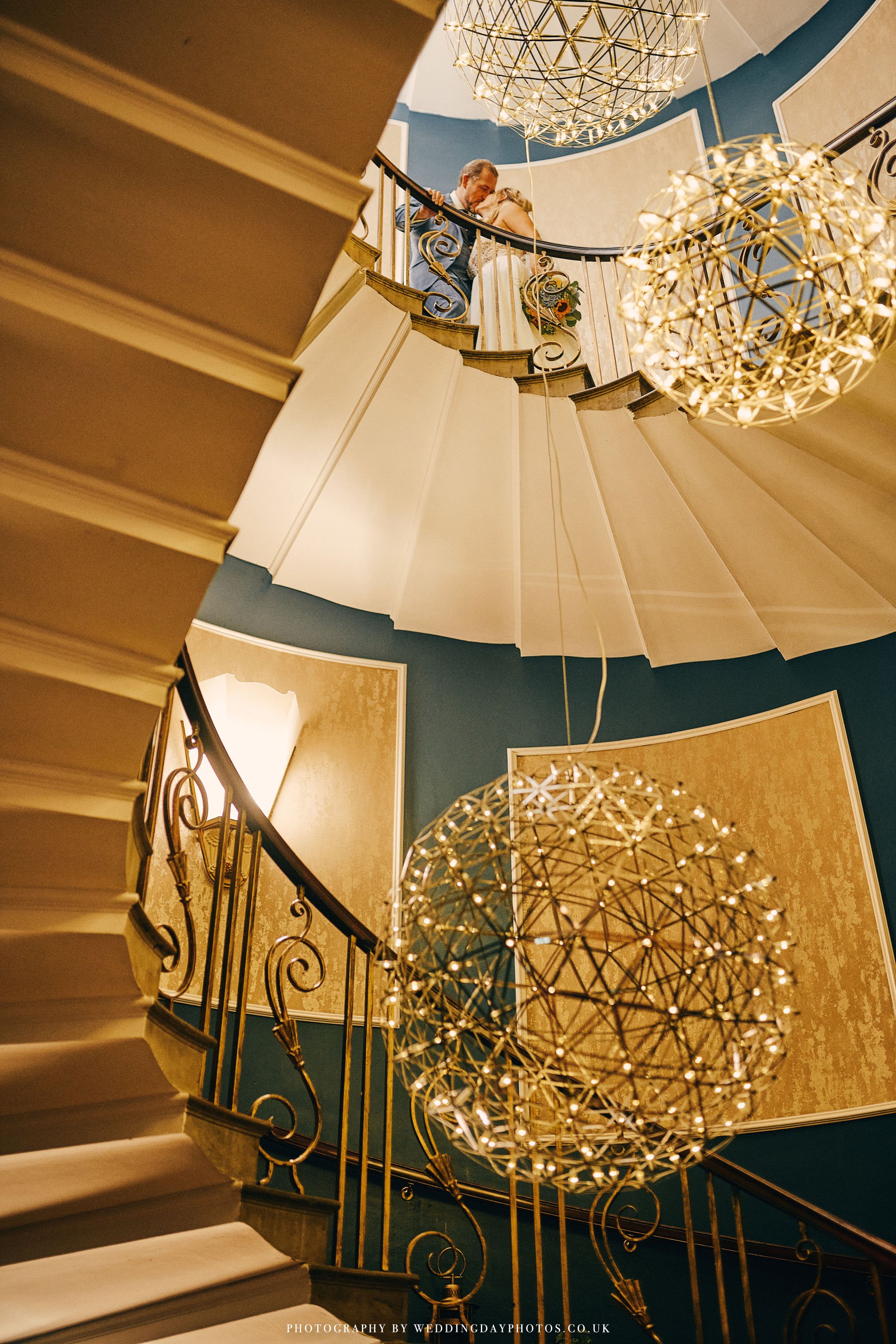 stunning staircase at manchester hall wedding with bride and groom