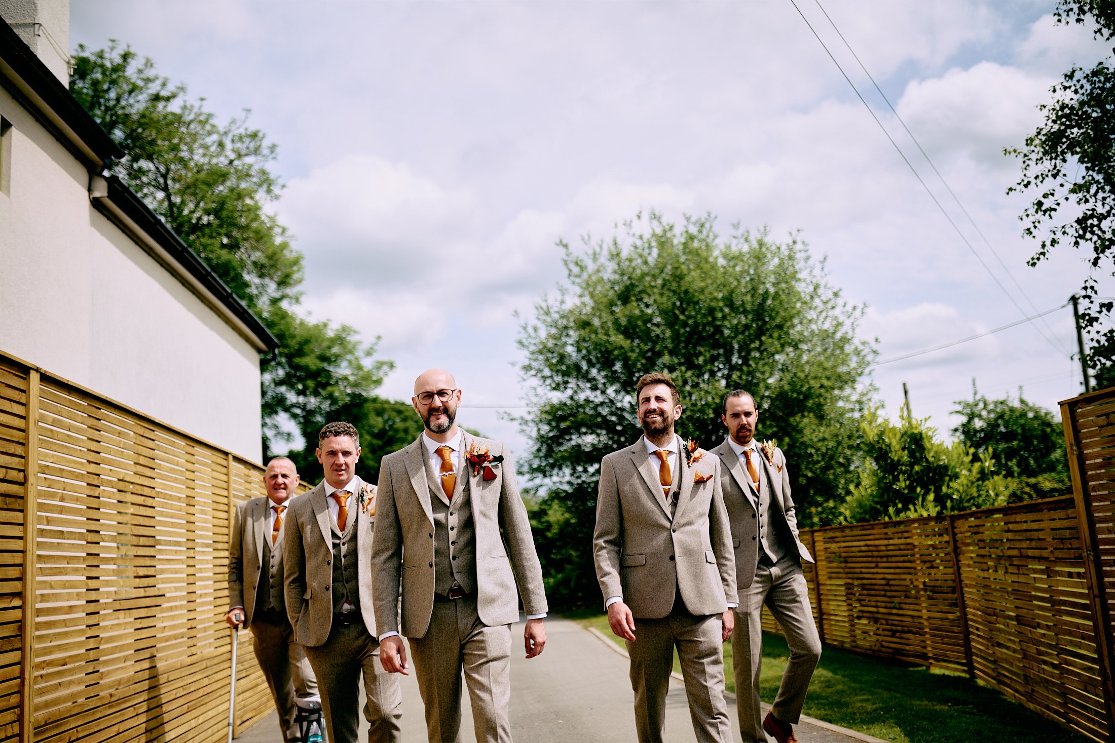 groom and groomsmen walking into Larkspur Lodge