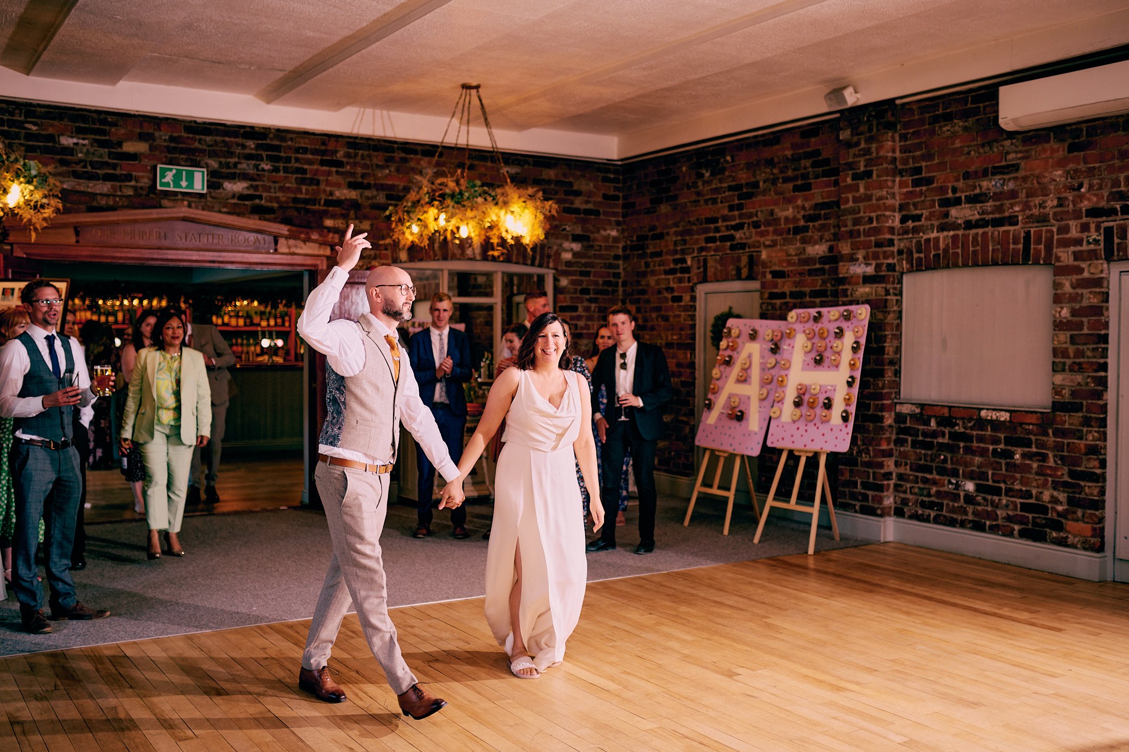 bride and groom walk onto the dance floor at Larkspur Lodge