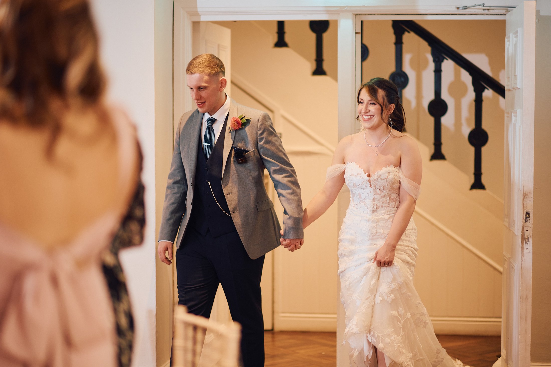 couple enter the room for wedding breakfast  at sparth hall