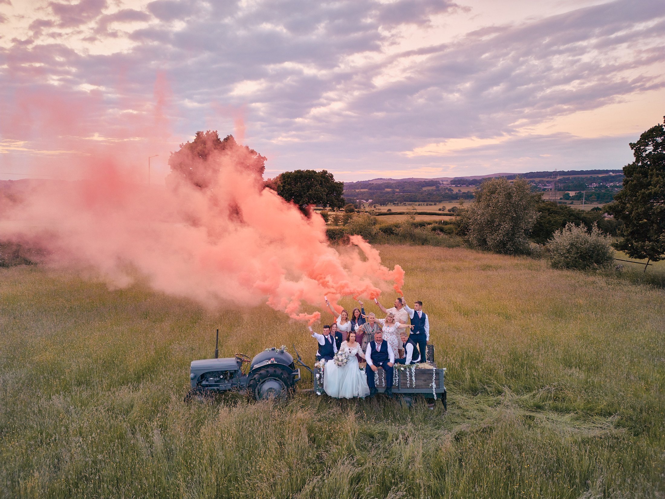 pink smoke bombs with bridal party at festival theme wedding