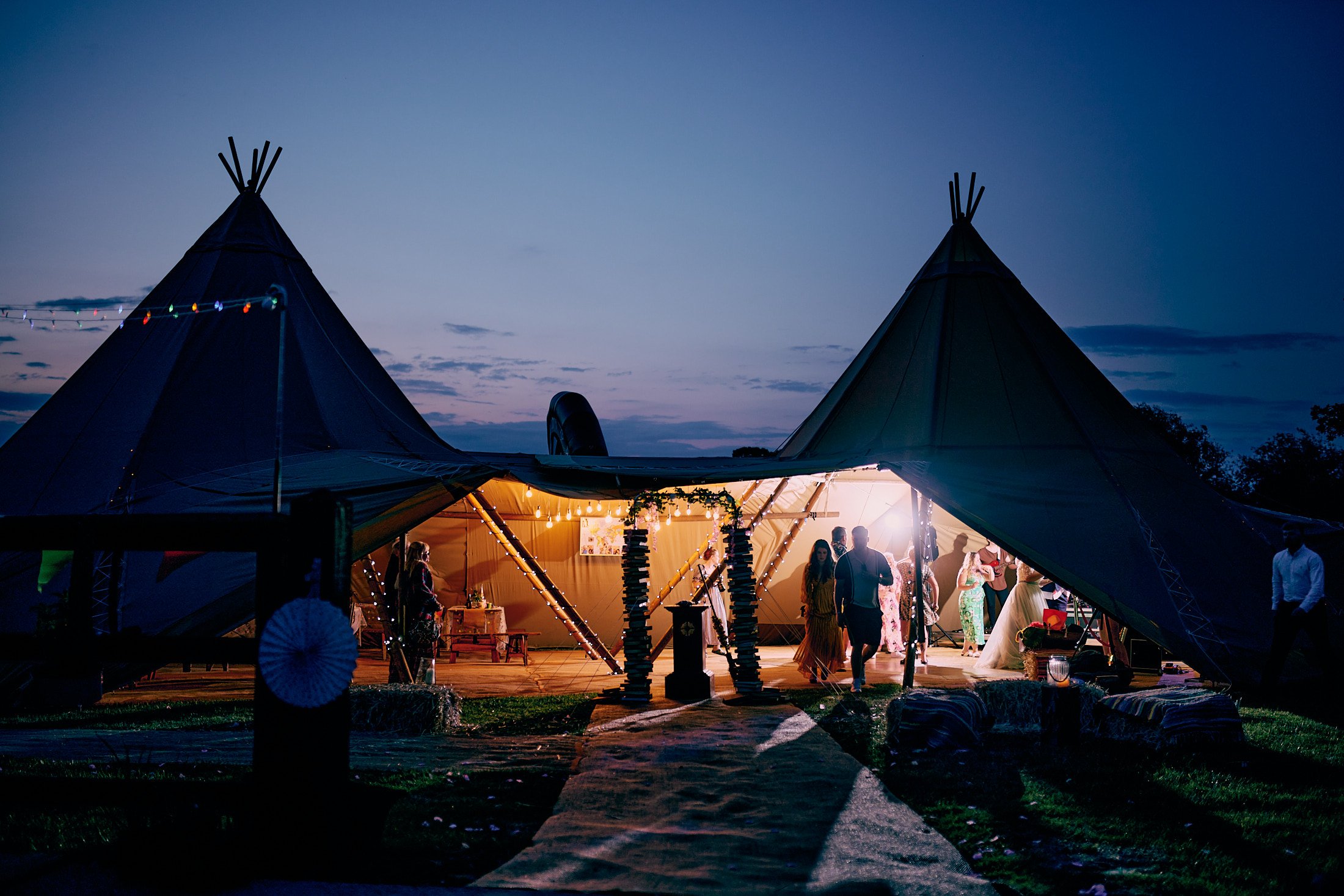party in teepee tent at festival theme wedding