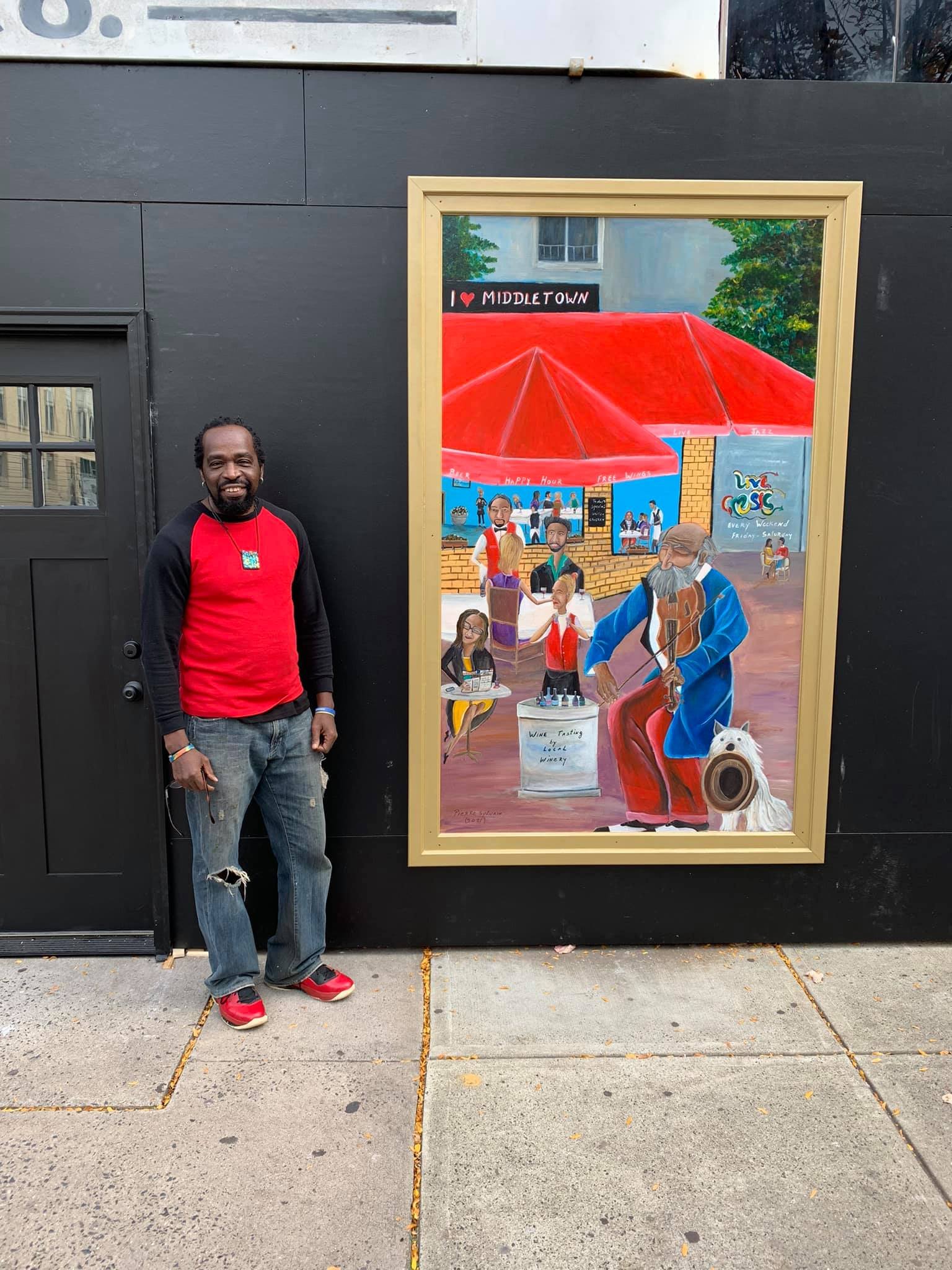 Pierre Sylvain in front of I Love Middletown painting.jpg