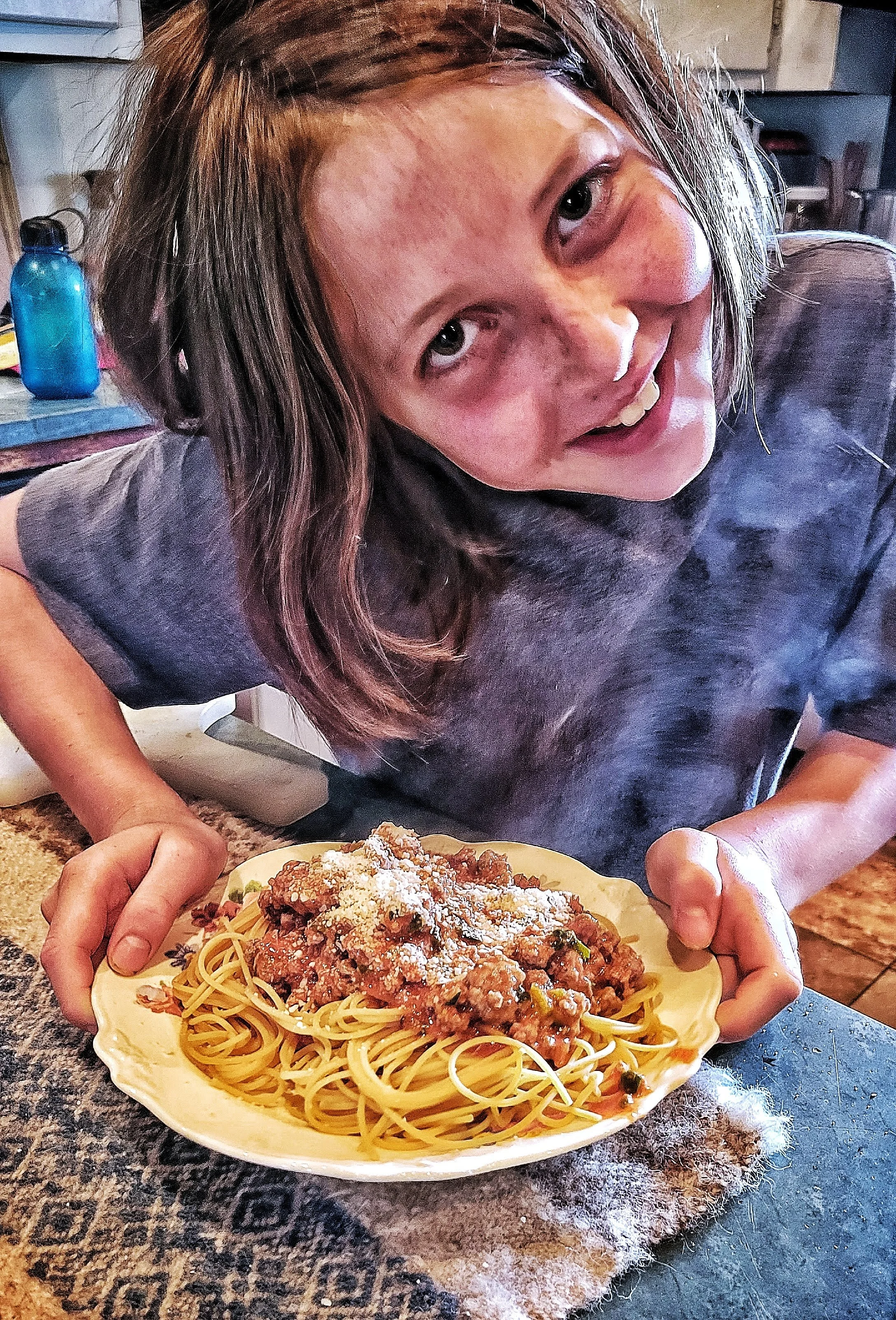Smiling Boy with homemade spaghetti with meat sauce