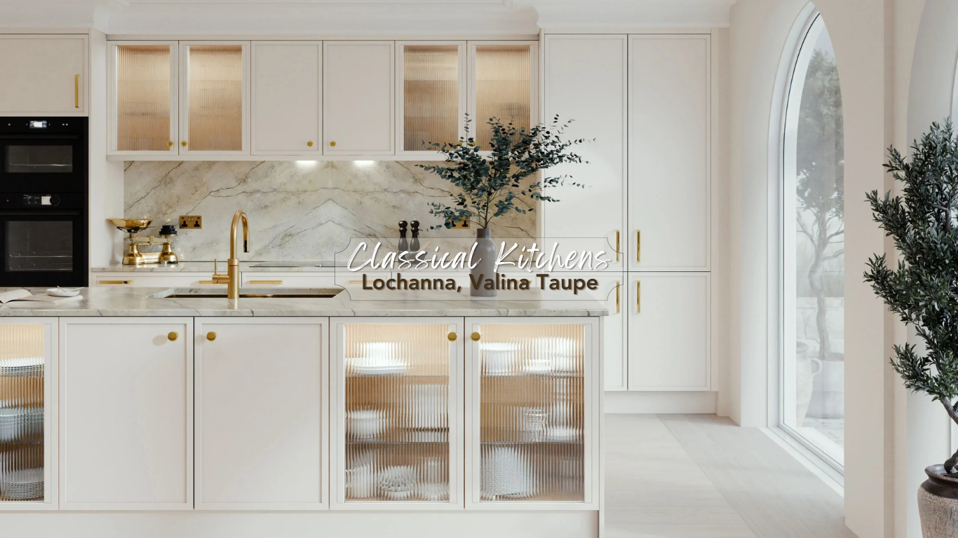 Bright, modern kitchen with white cabinets, gold hardware, a marble backsplash, and a large window with trees outside. A dark vase with greenery and a gold scale are on the countertop.