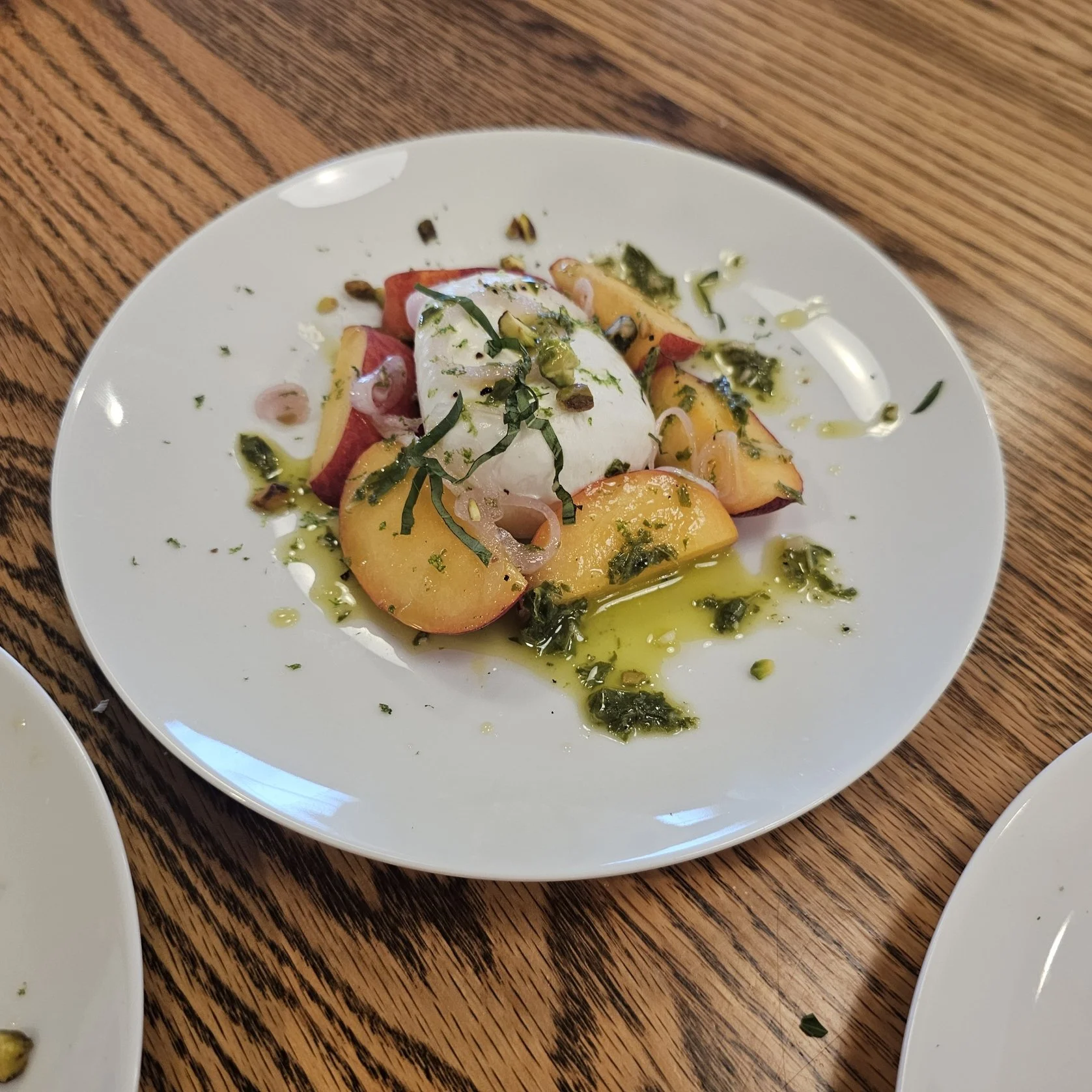 Burrata, Basil oil, fresh basil, pistachios, peaches, lime zest 