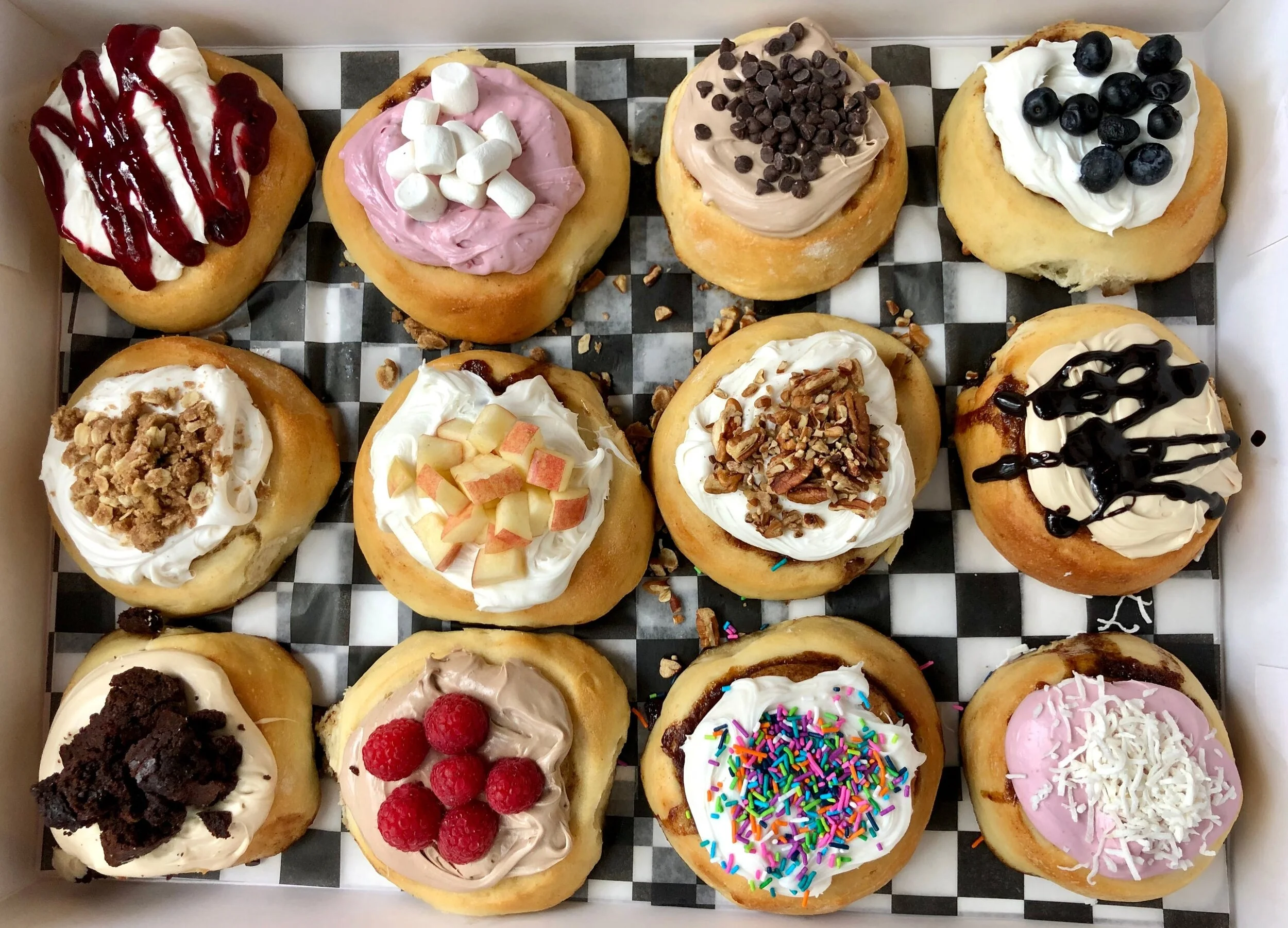 12 different Cinnaholic cinnamon roll combinations.jpeg